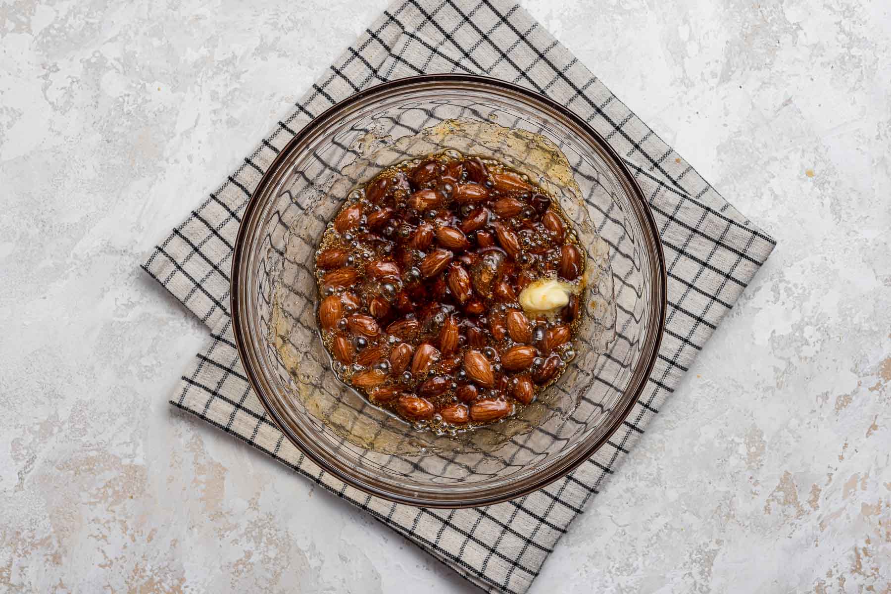 Almonds cooked in sugar with butter dollop.