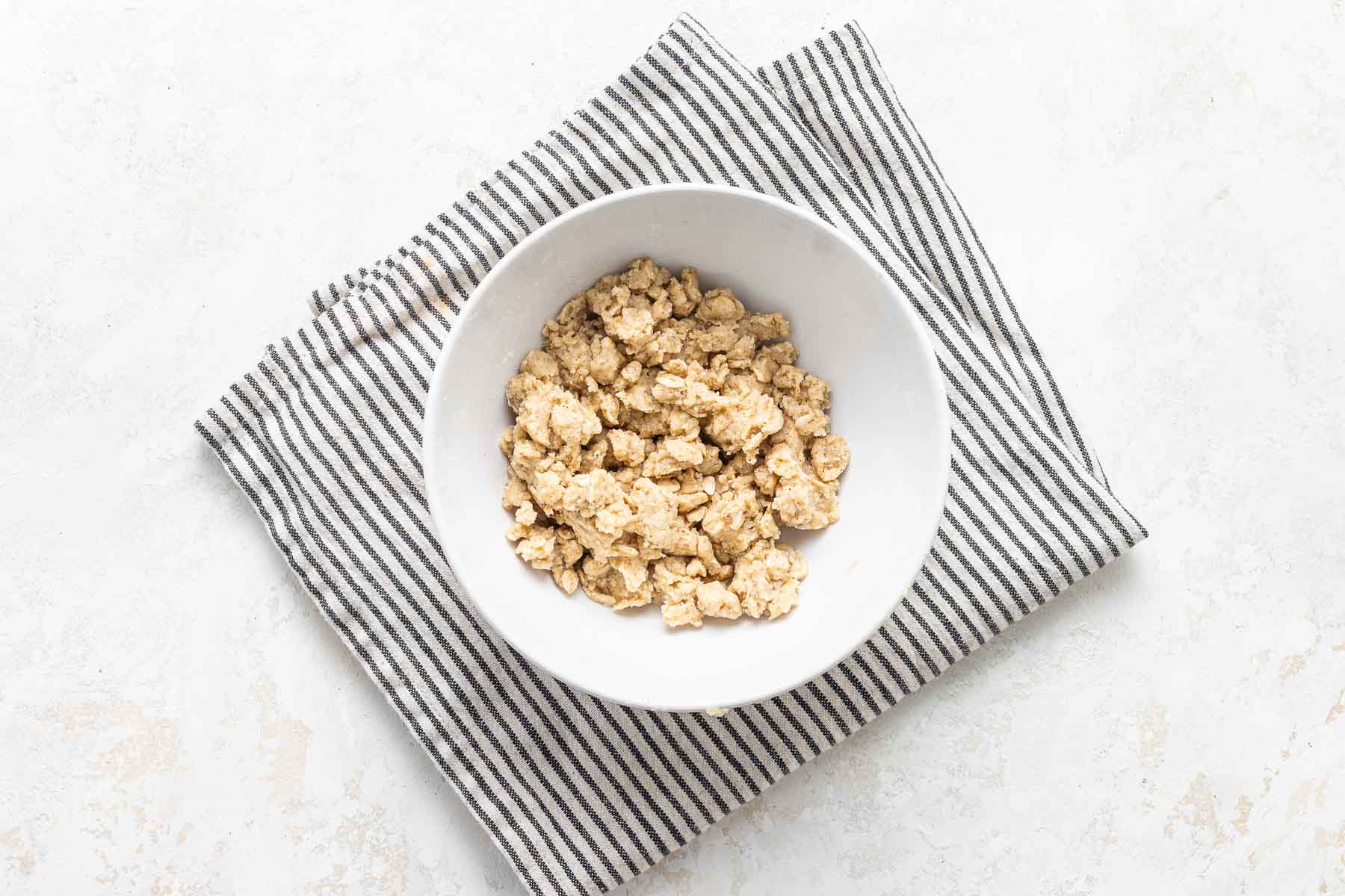 Apple crisp topping with oats in bowl.