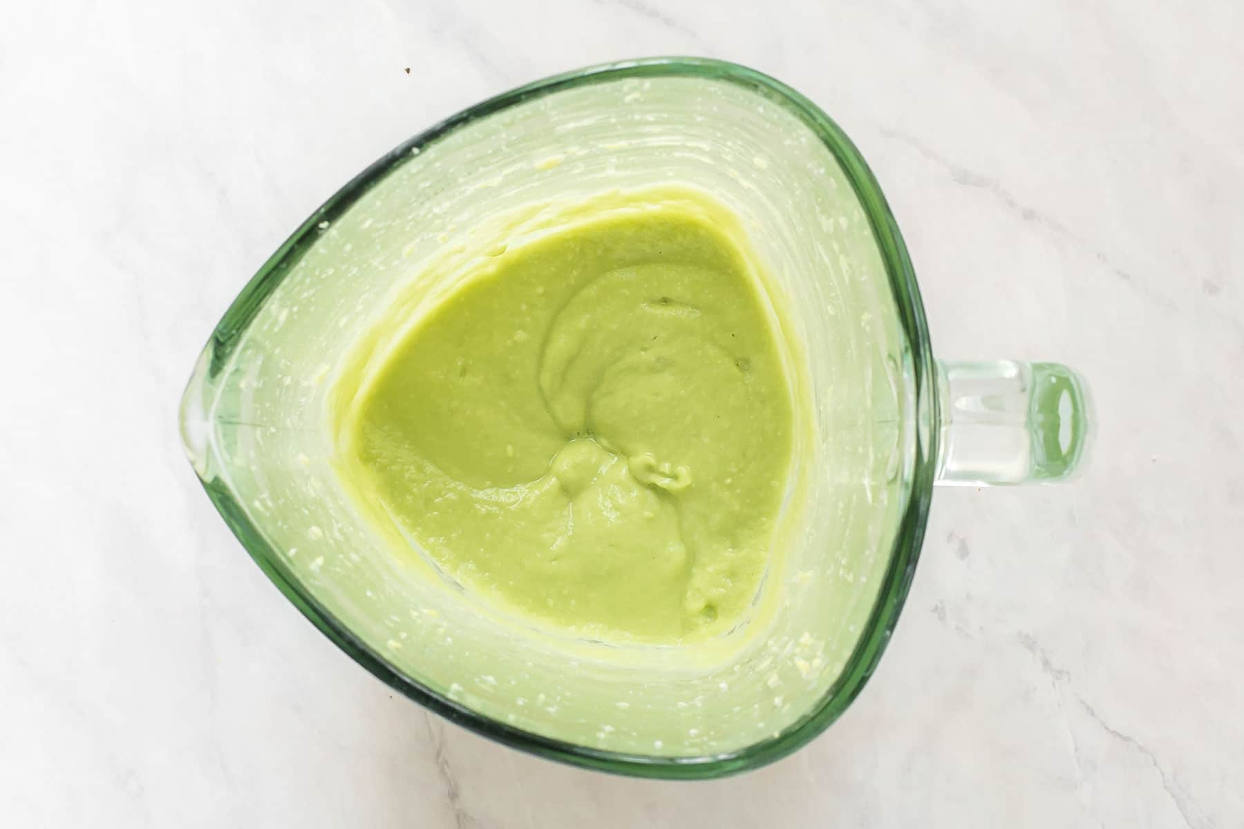 Smooth avocado sauce in blender.