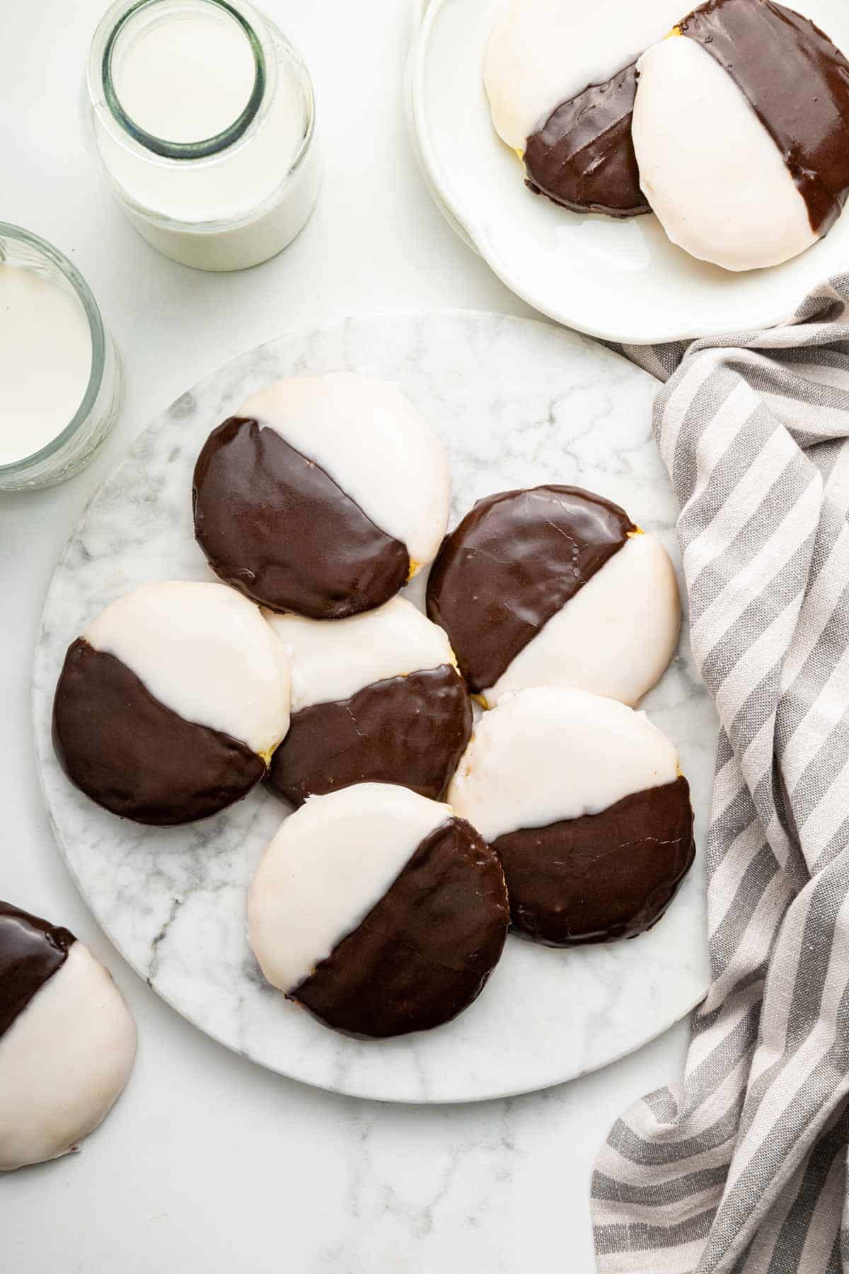 Black and white cookies on marble plate.