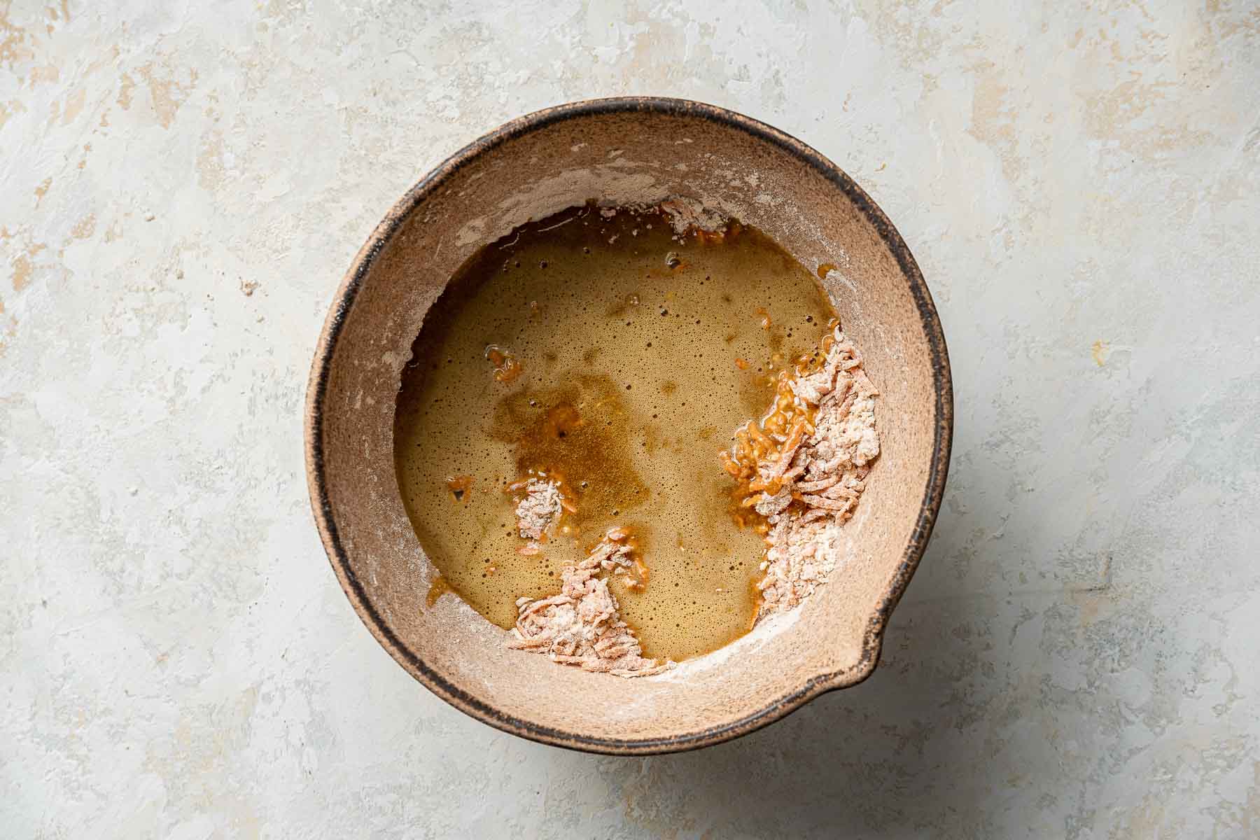 Combining wet and dry ingredients for cupcakes.