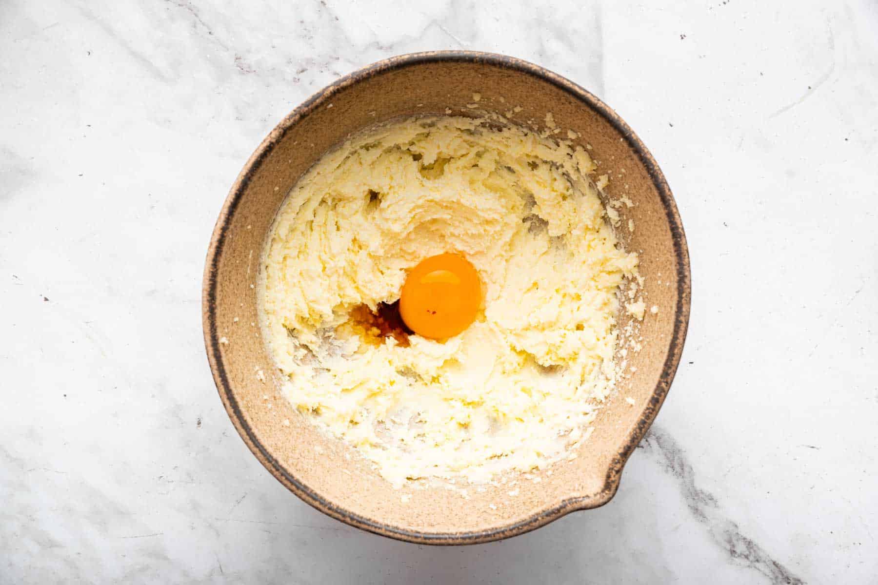 Whipped yellow butter batter with egg and vanilla on top.