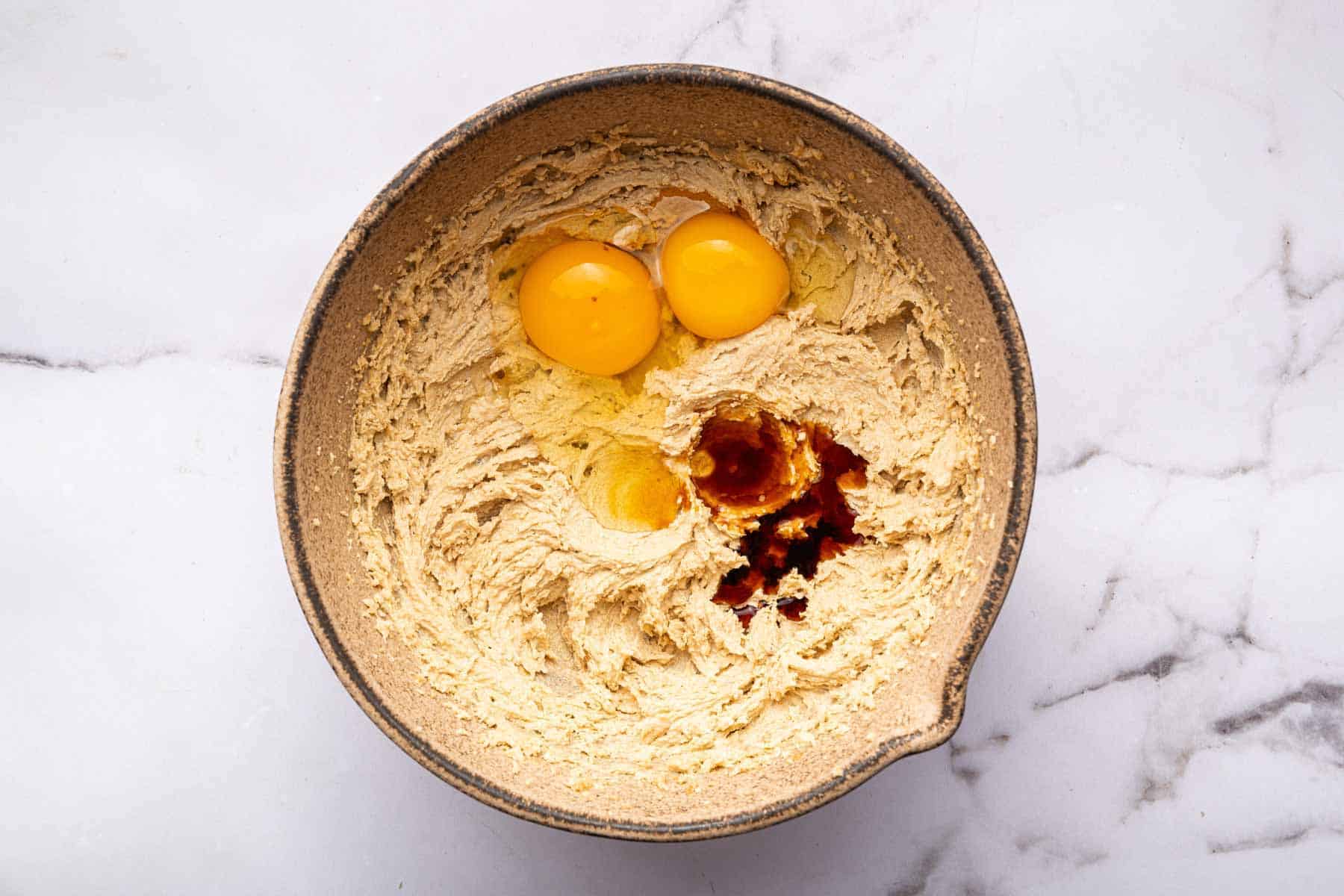 Yellow batter with two egg yolks and vanilla splashed on top.