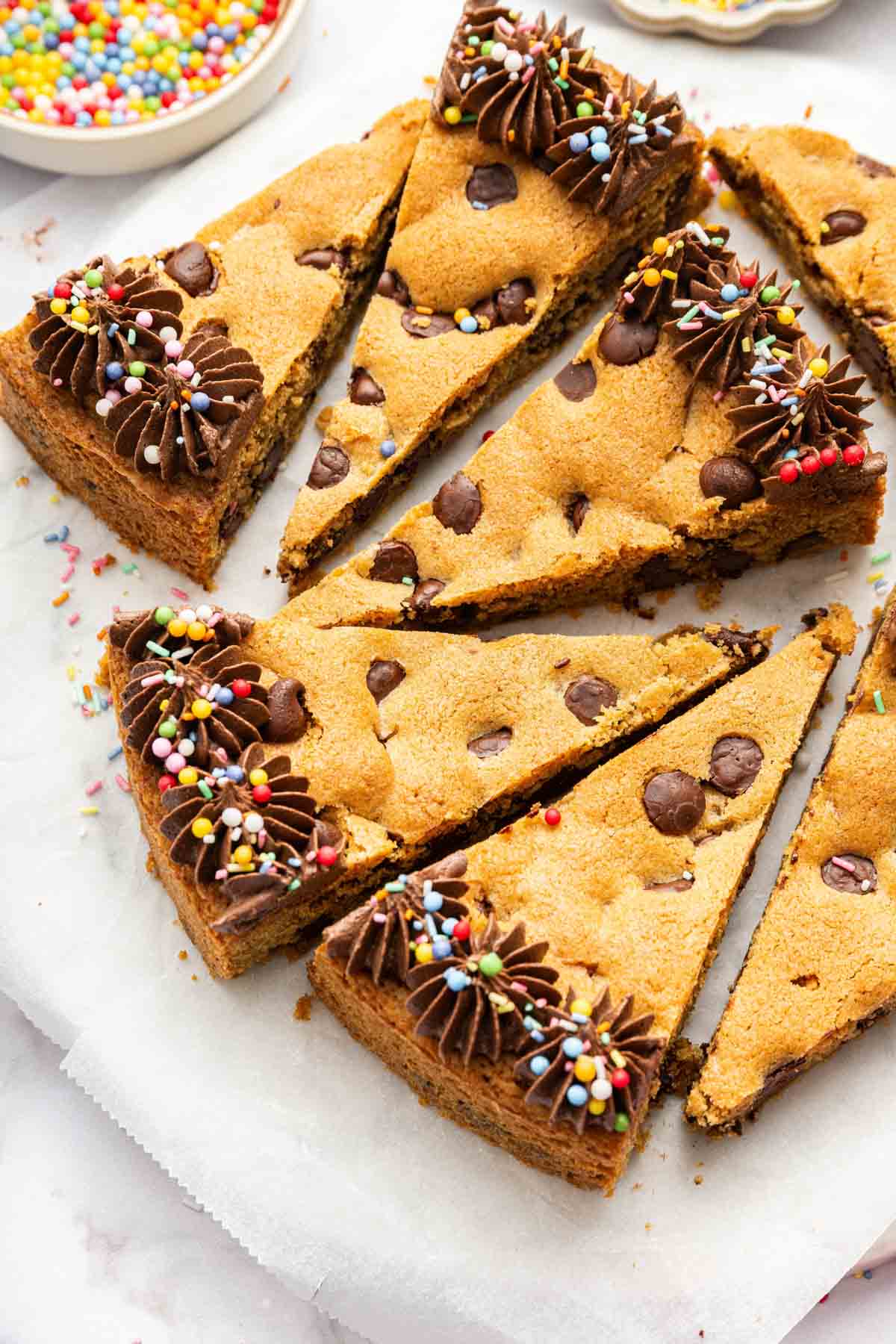 Triangle desserts near each other on a white platter.