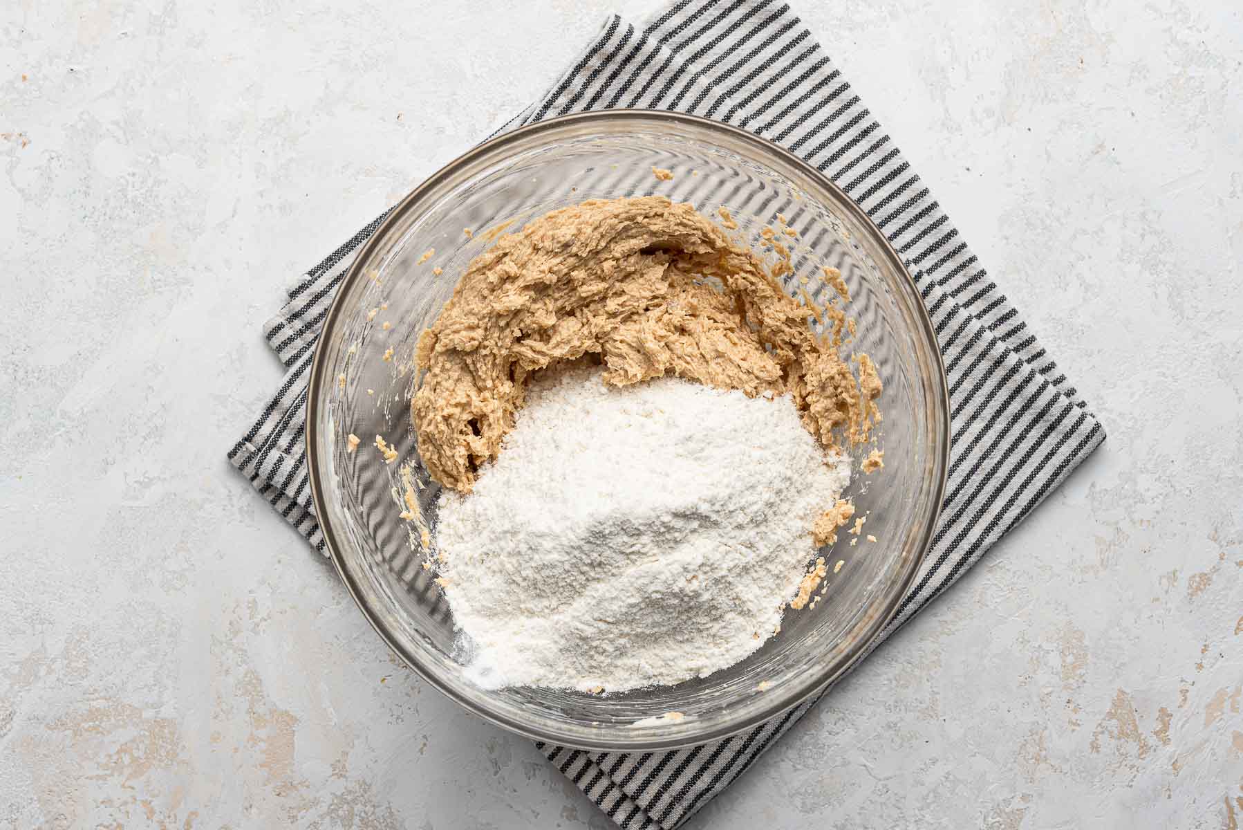 Dry ingredients over wet in clear bowl.