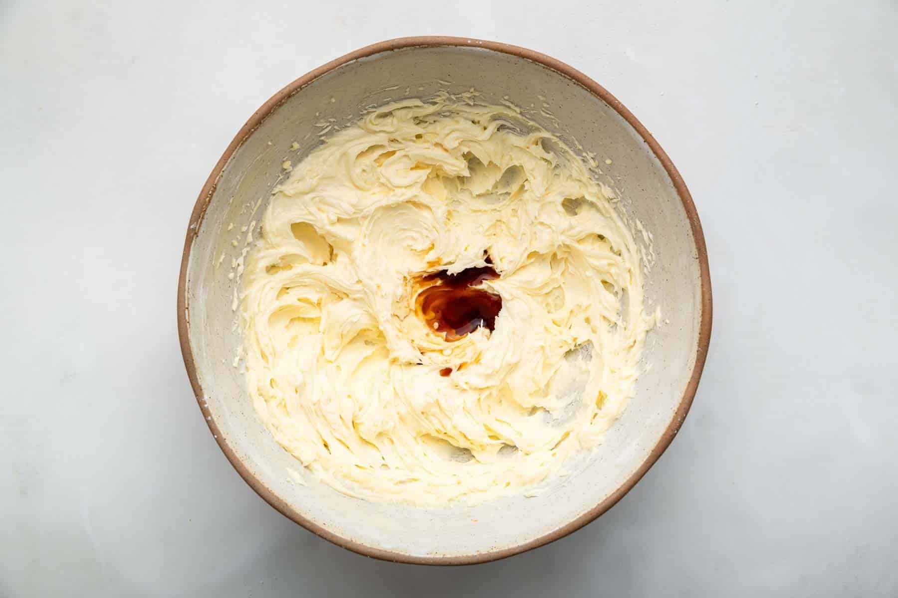 Bowl with creamed butter and a splash of brown vanilla on top.