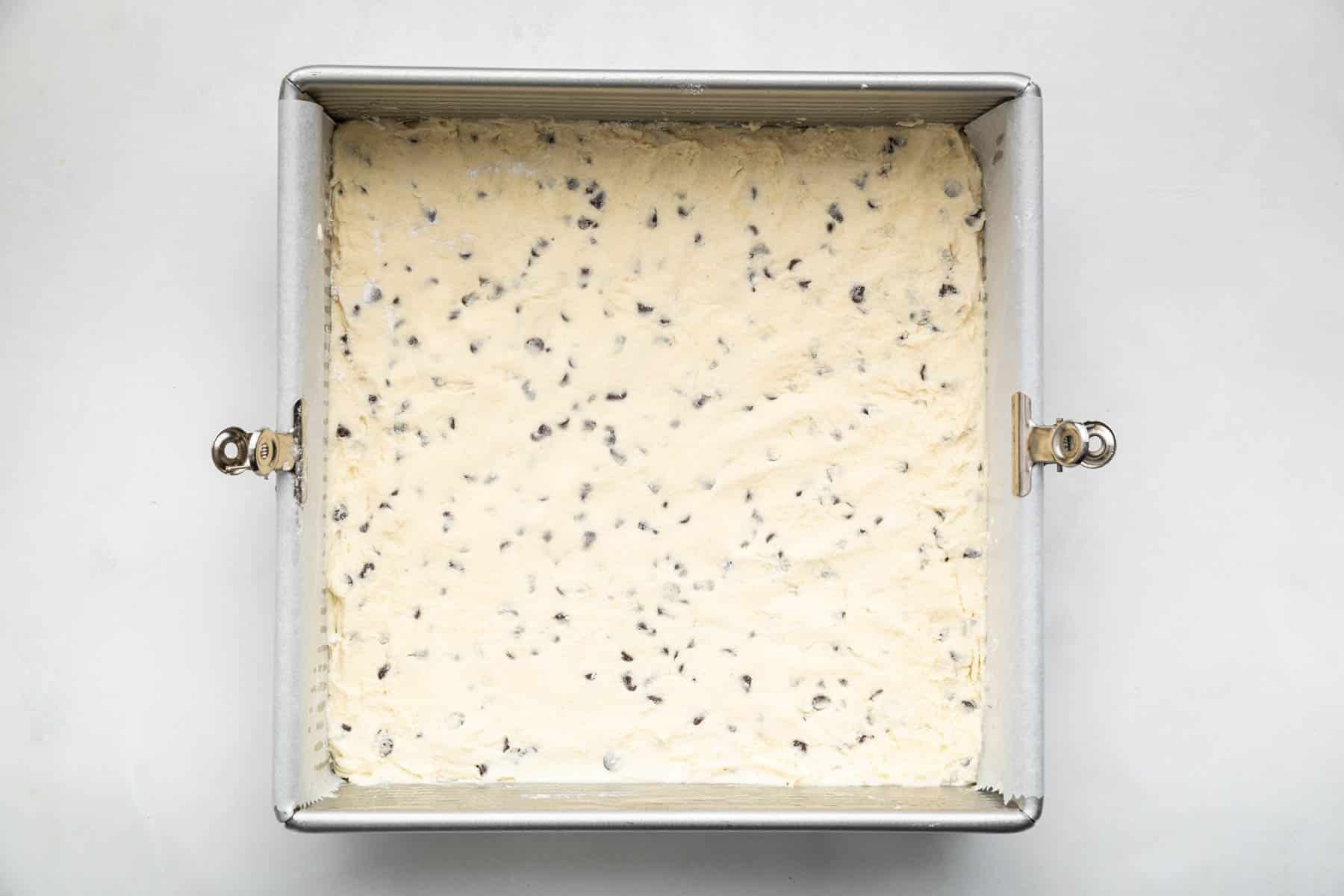Raw dough in a square 8-inch pan before being baked.