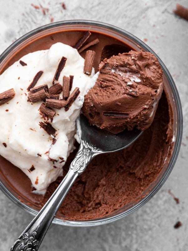 Super close shot of chocolate mousse with spoon removing a bite.