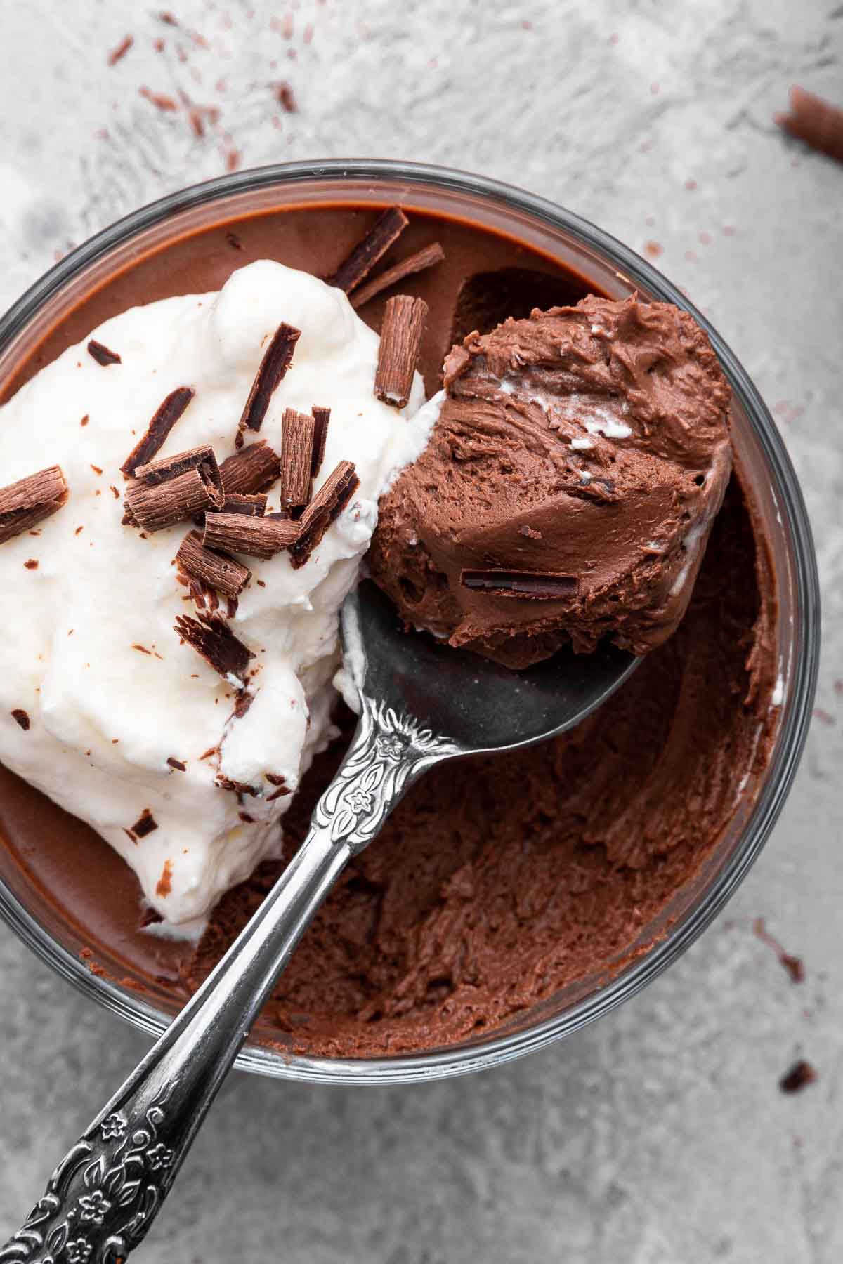 Super close shot of chocolate mousse with spoon removing a bite.