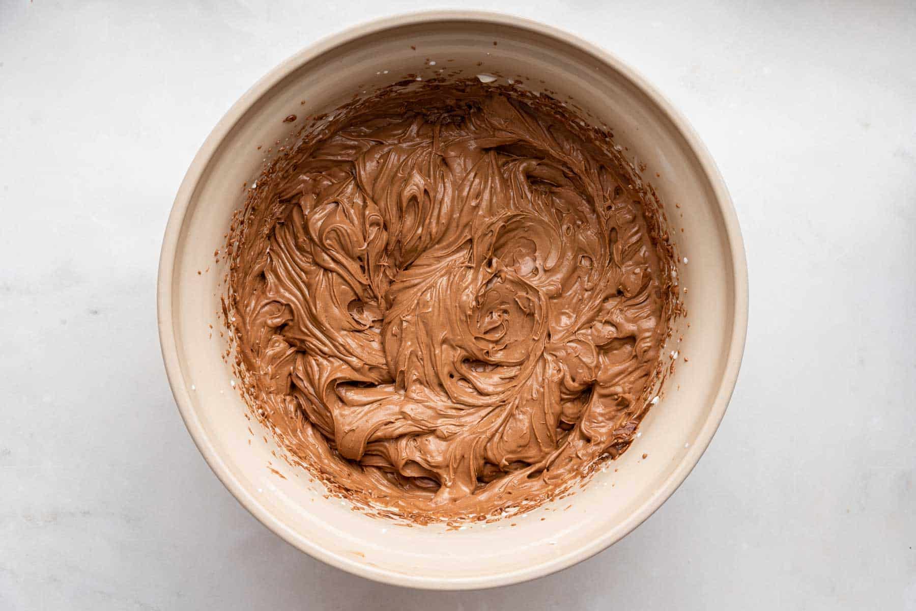 Fluffy chocolate mousse in a cream bowl, freshly whipped.