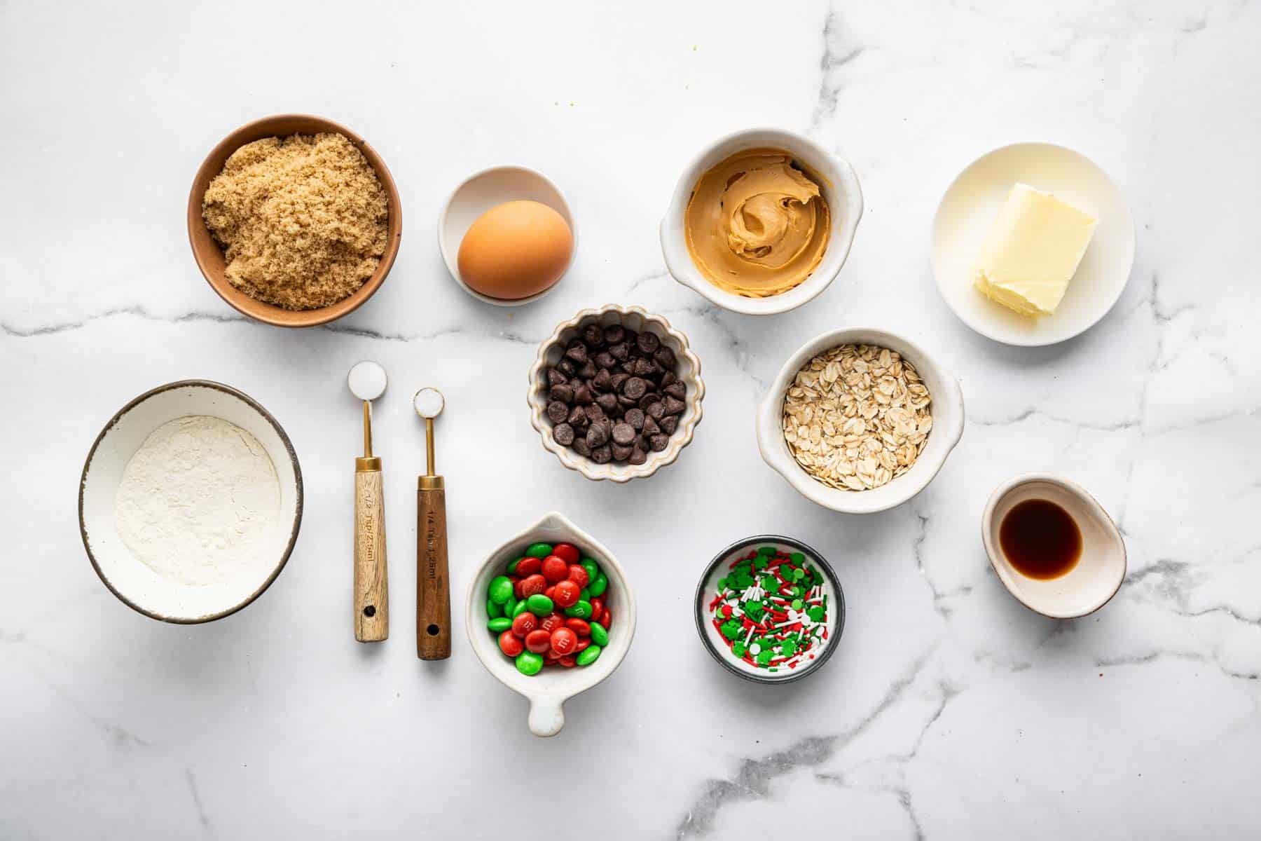 Small bowls of brown sugar, M&Ms, oats, and peanut butter.