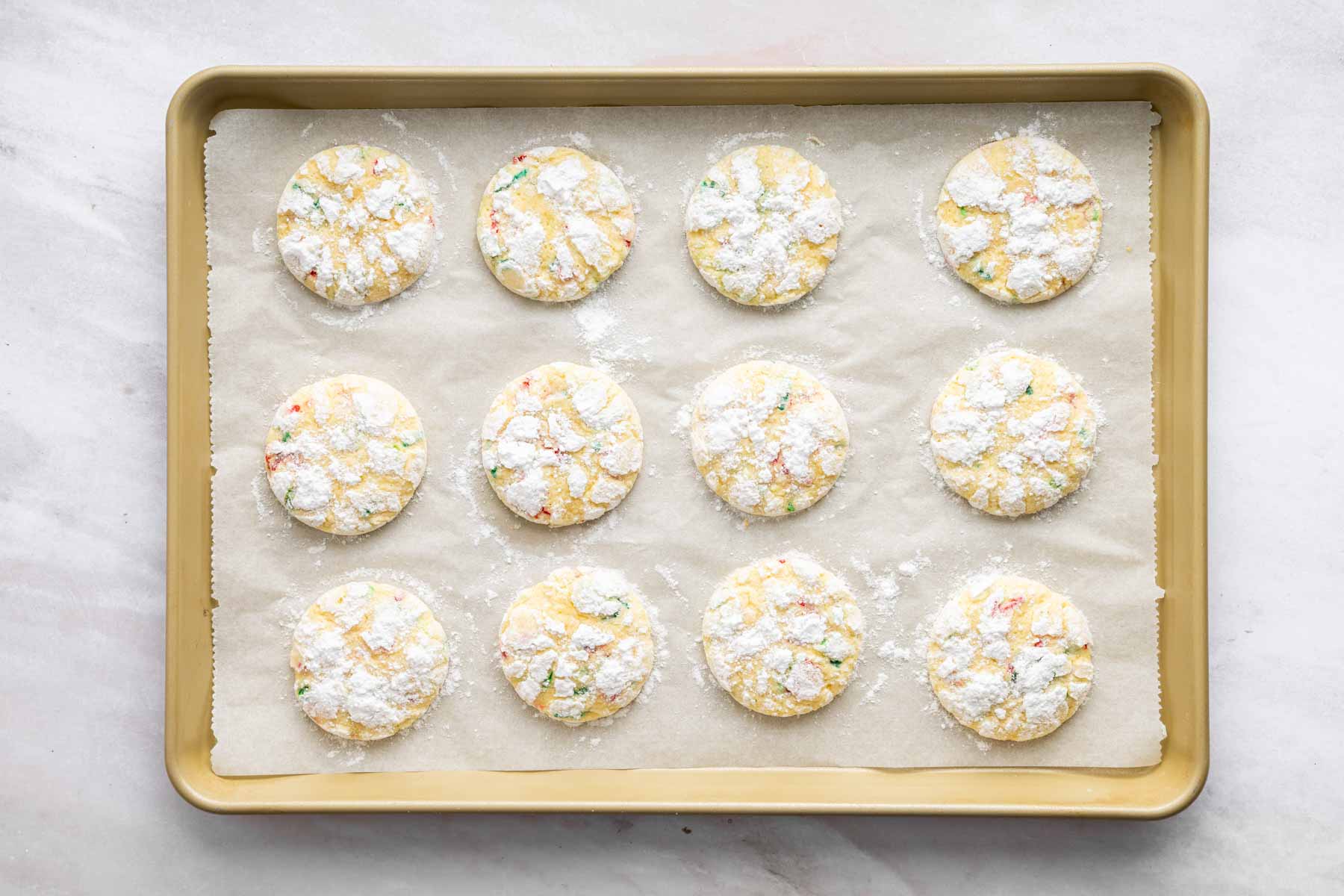 Freshly baked white crackly treats with red and green sprinkles.
