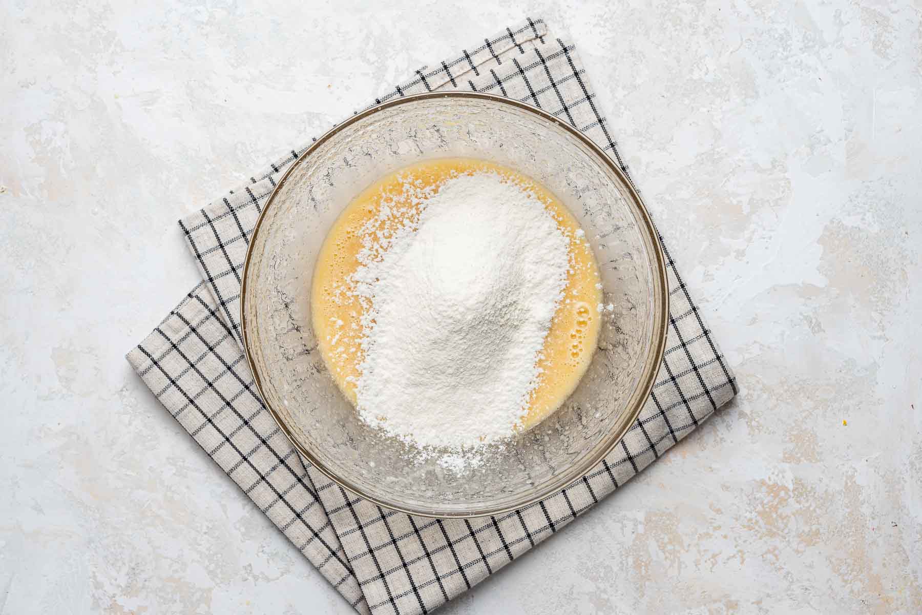 Flour on cupcake batter in bowl.