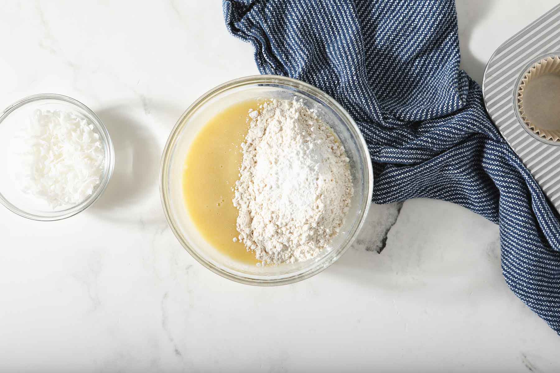 Adding flour to muffin batter.