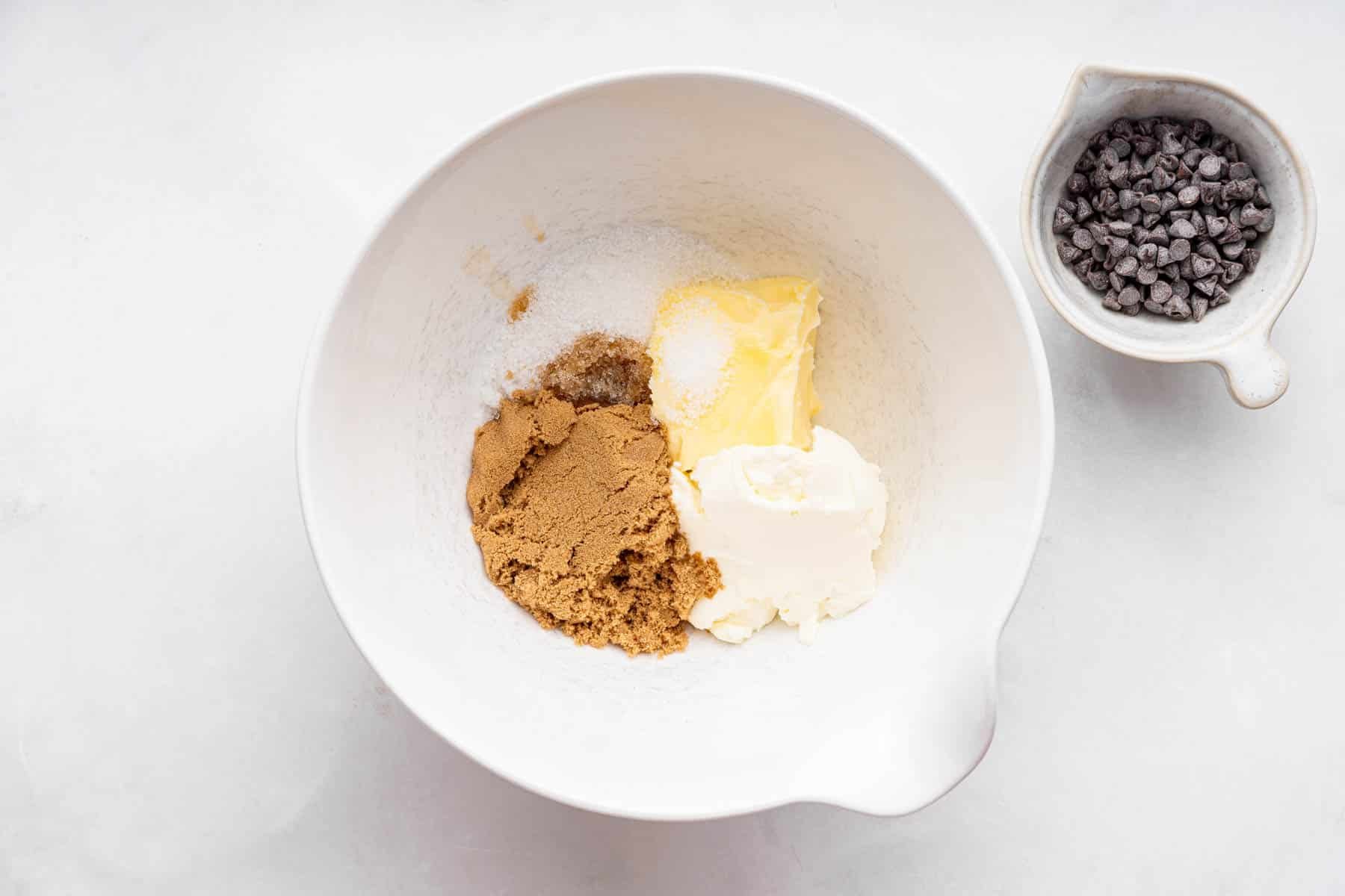 Bowl with butter and sugars and chocolate chips on the side.