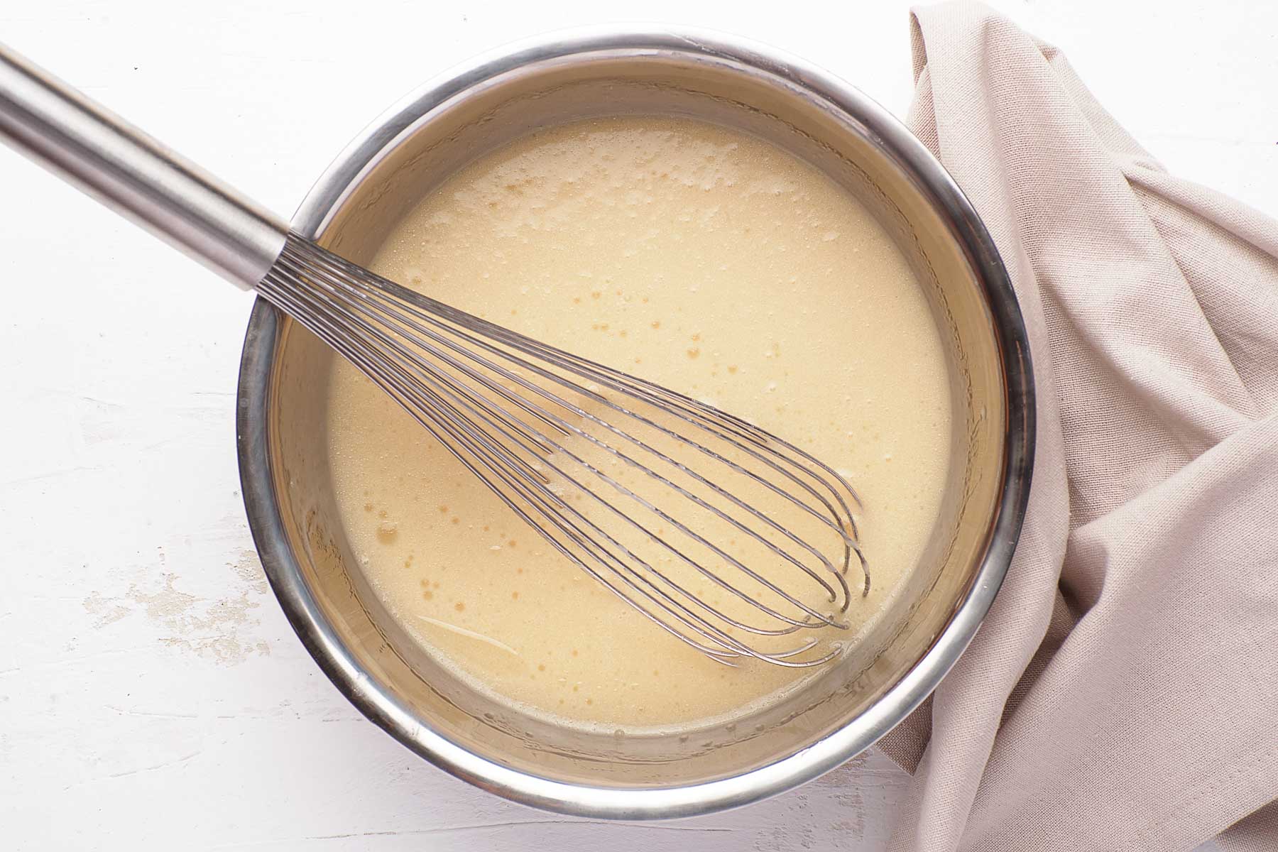 Oil, brown sugar and vanilla whisked together in metal bowl.