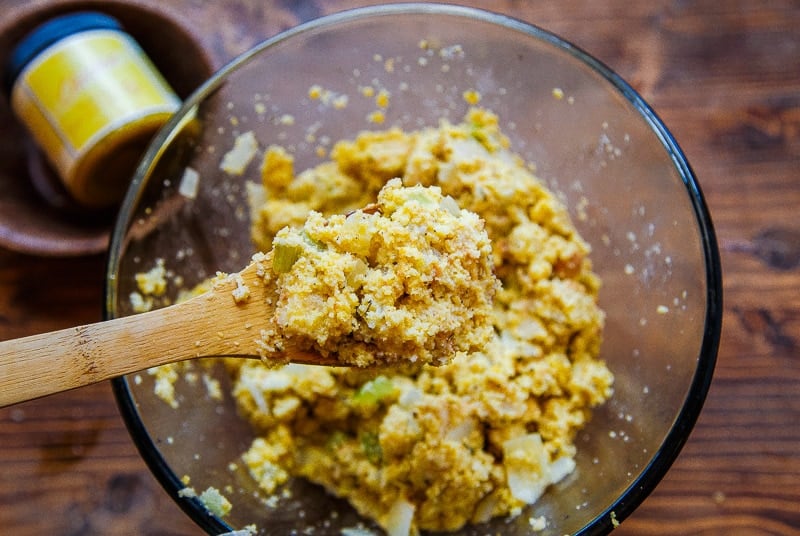 Wet cornbread dressing in bowl before being baked.