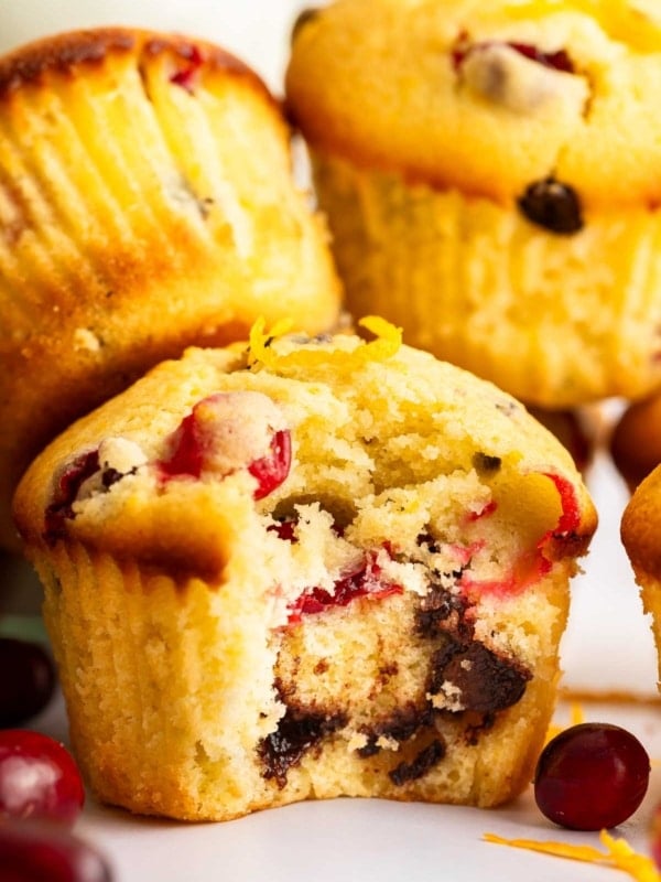 Stack of cranberry orange muffins with chocolate chips.