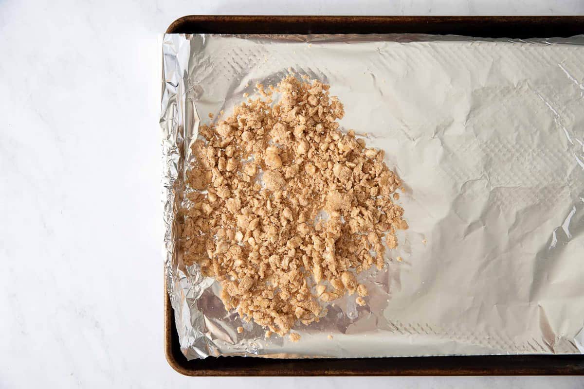 Raw crumb topping on a baking pan
