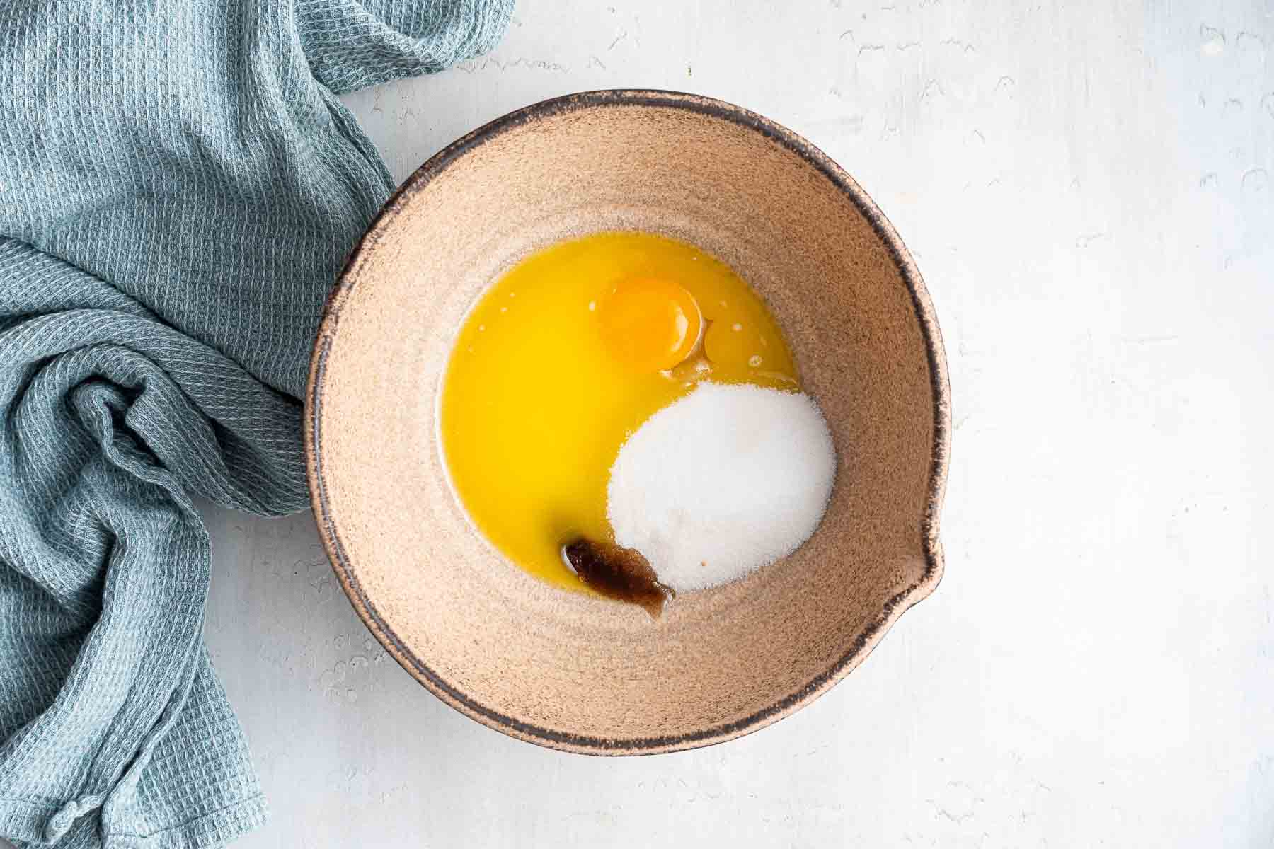 Mixing bowl with melted butter, egg, sugar and vanilla.