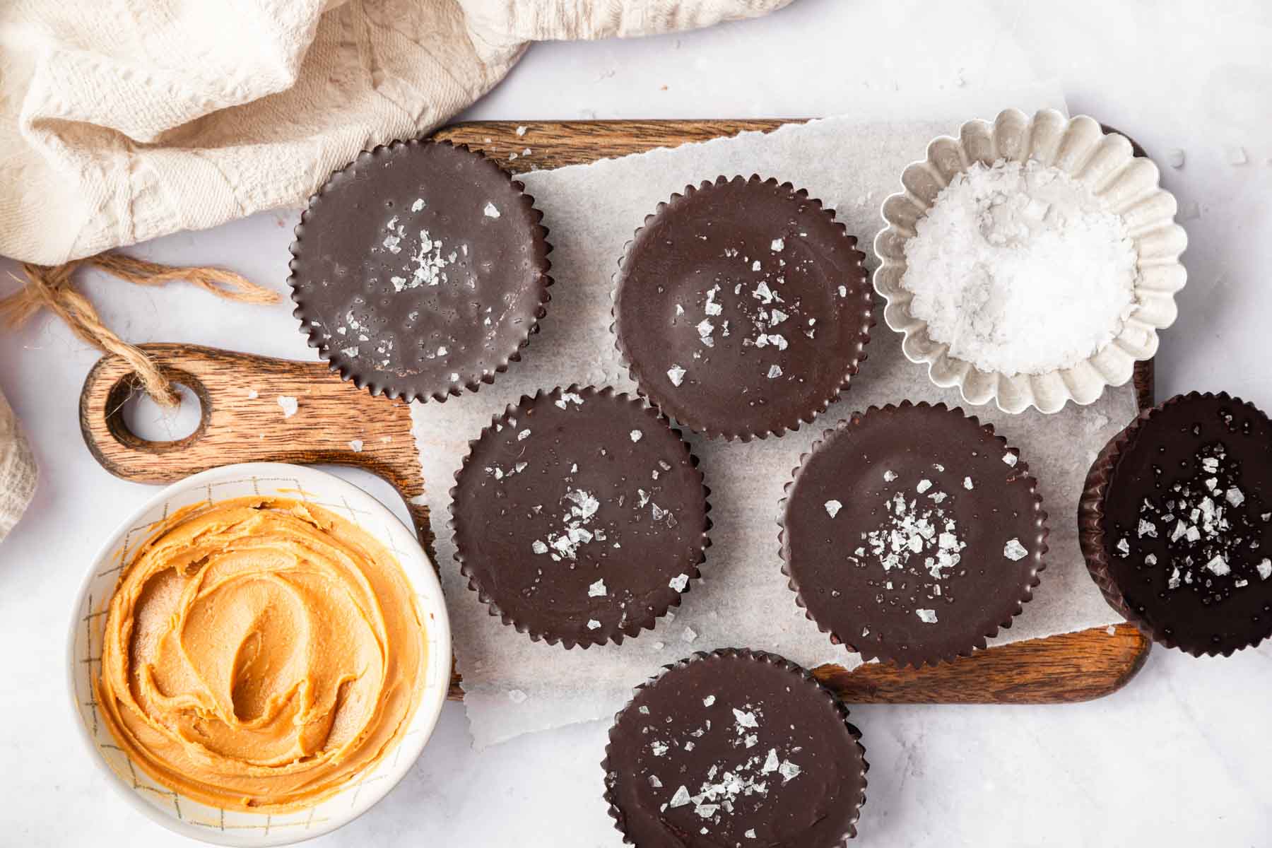 Peanut butter cups topped with flaky sea salt.
