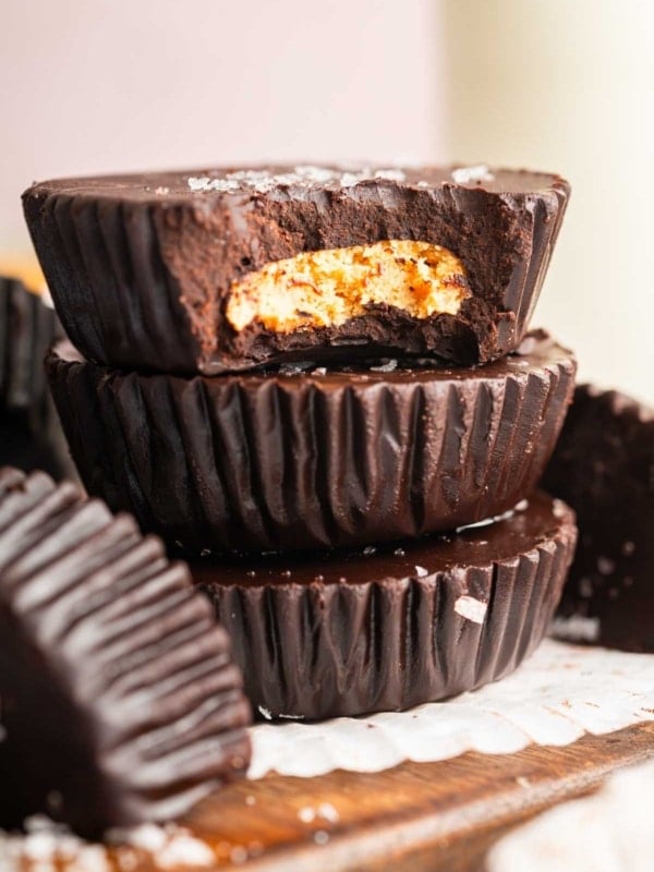Stack of homemade peanut butter cups with bite missing from top.