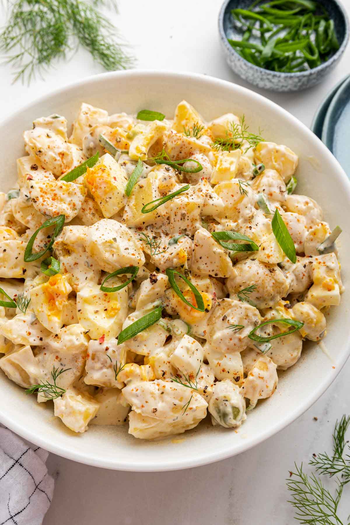 Five minute potato side dish in white bowl with scallion garnish.