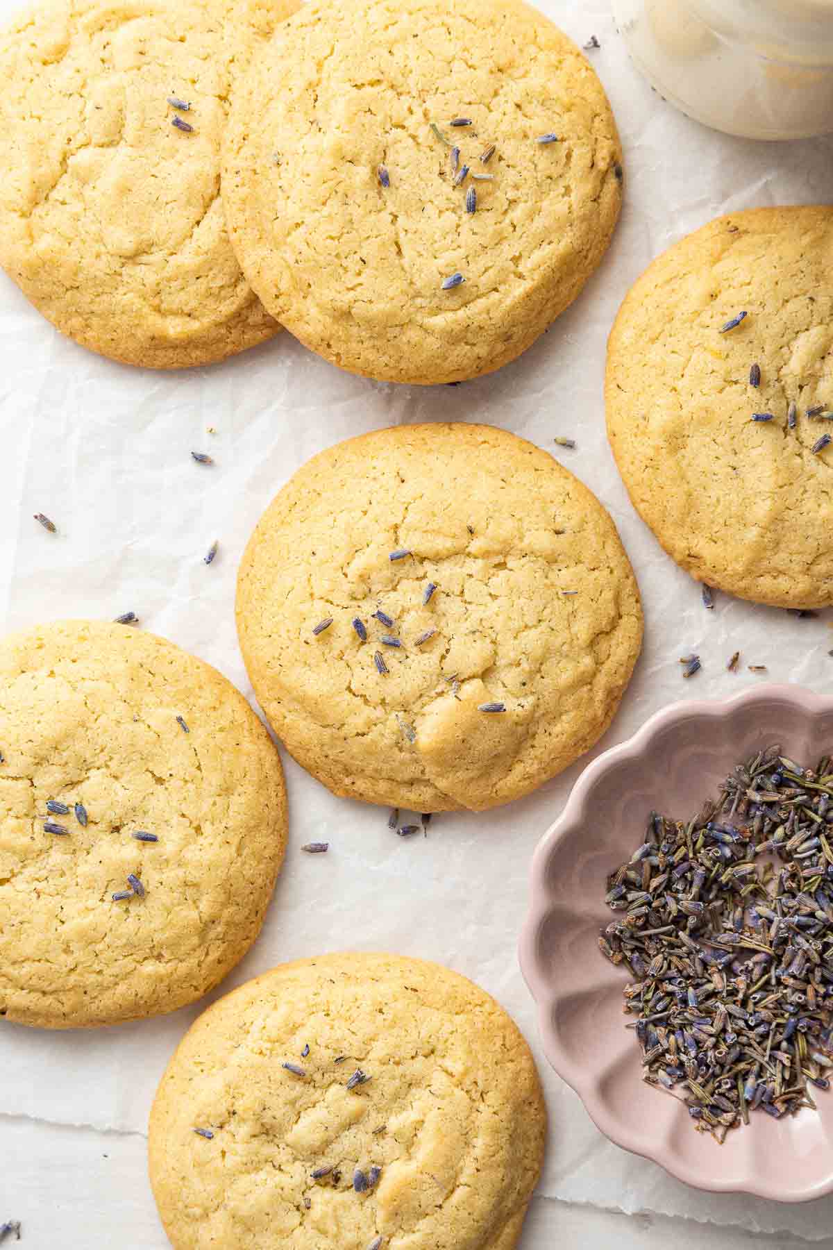 Overhead shot of lavender cookies with pink bowl of lavender buds.