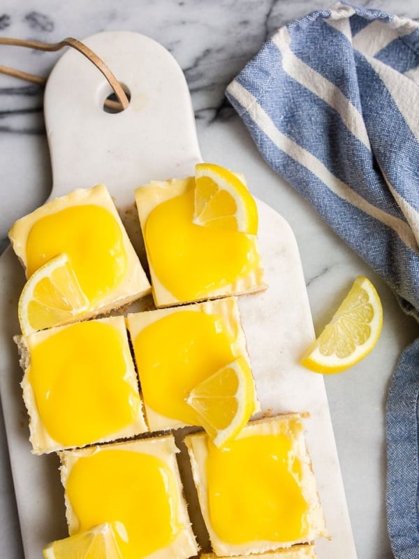 Lemon Cheesecake Bars with Homemade Lemon Curd. Cheesecake lemon bars are a fun, easy summer dessert.