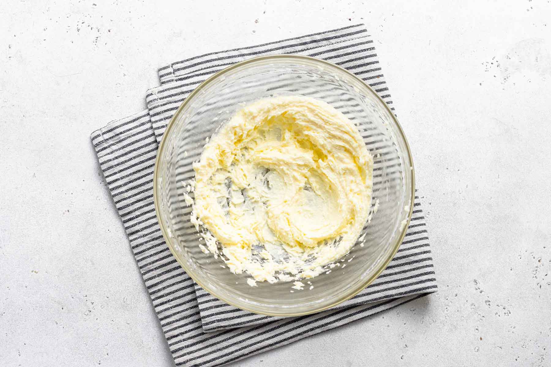 Butter and sugar, beaten together in clear bowl.