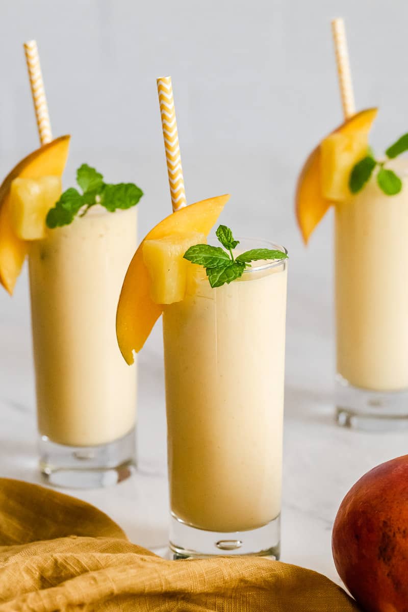Mango smoothies in three glasses.
