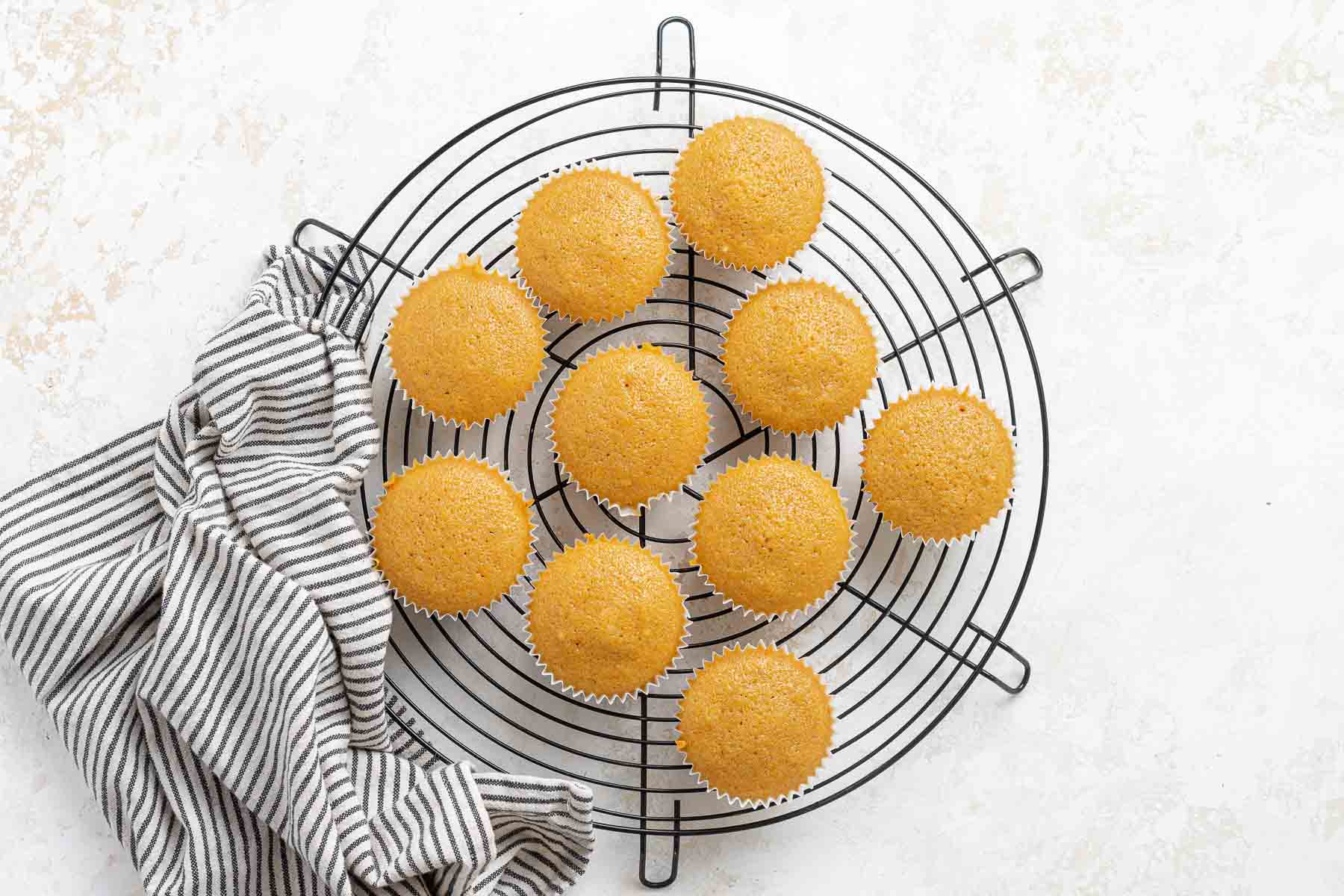 Cupcakes cooling on wire rack.