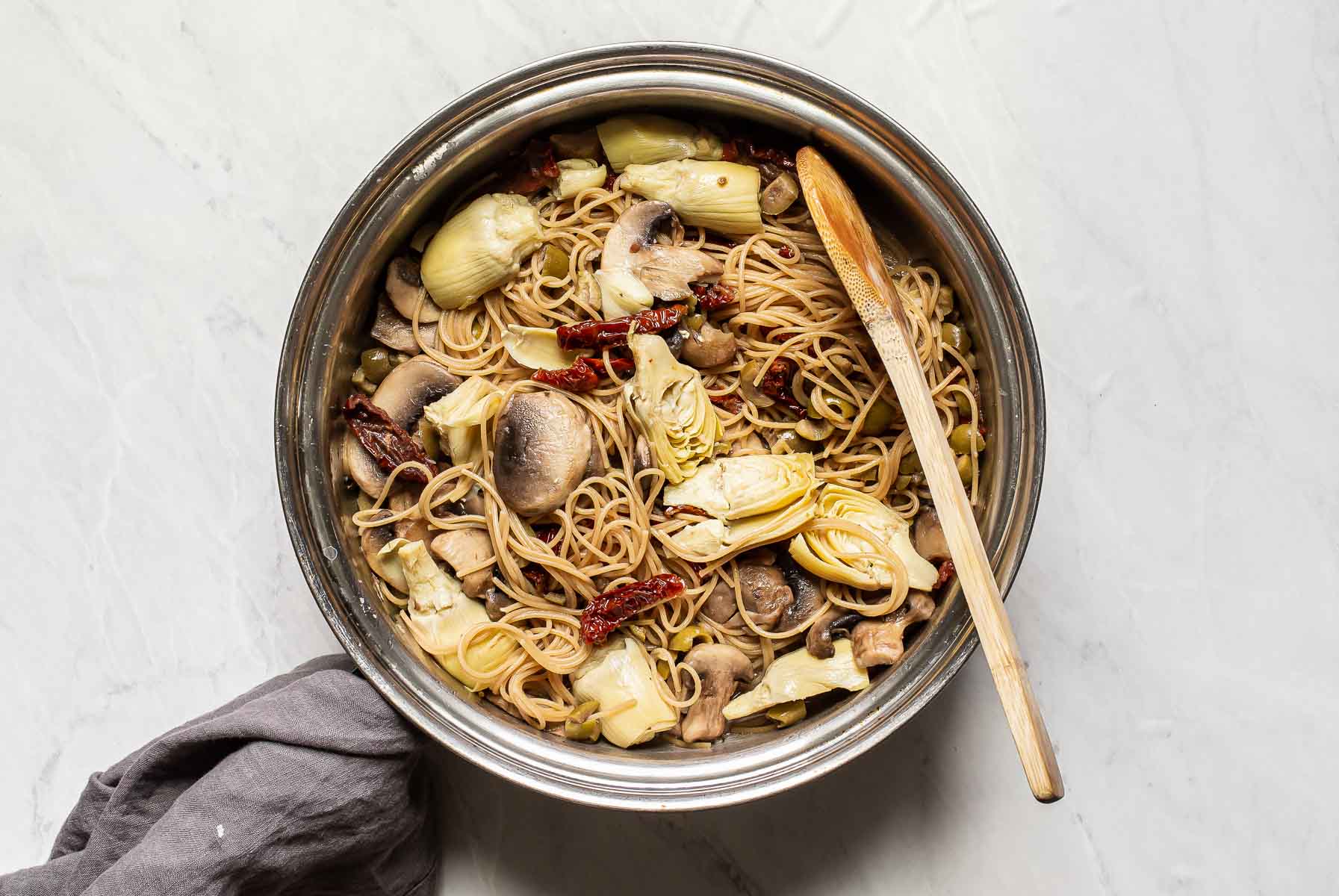 Pasta with vegetables in skillet.