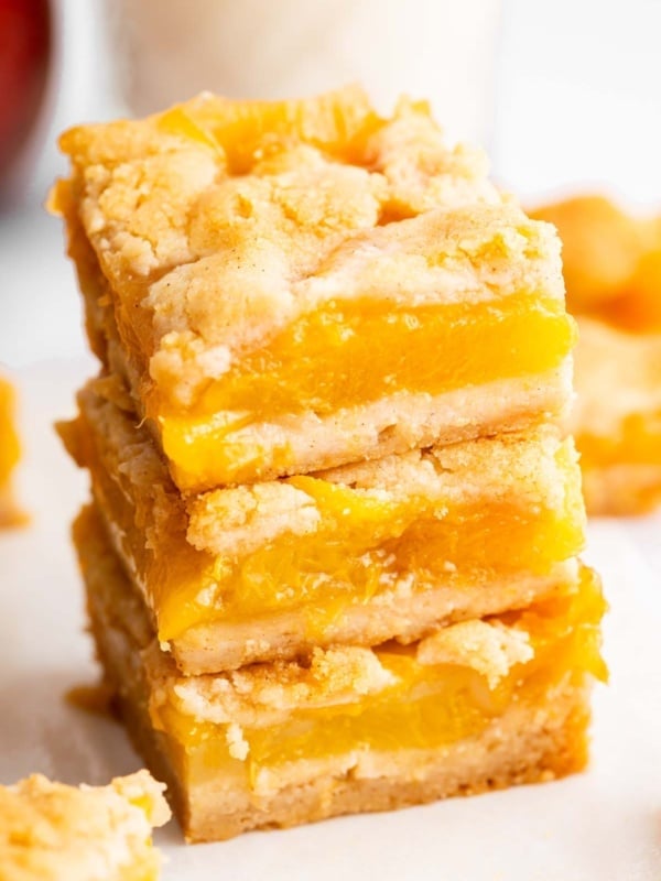 Stack of three peach pie bars on top of each other.