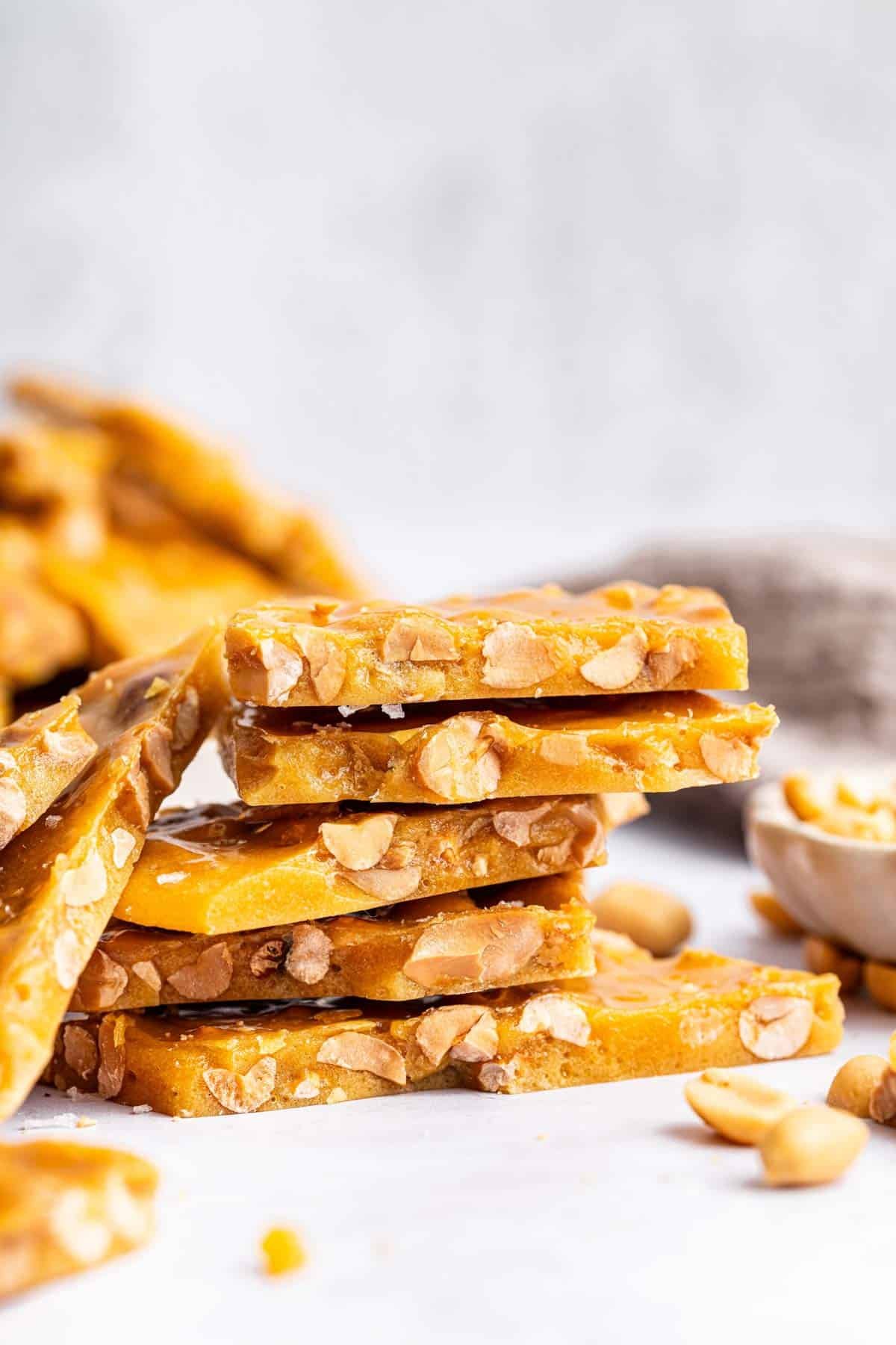 Stack of peanut brittle broken into pieces.