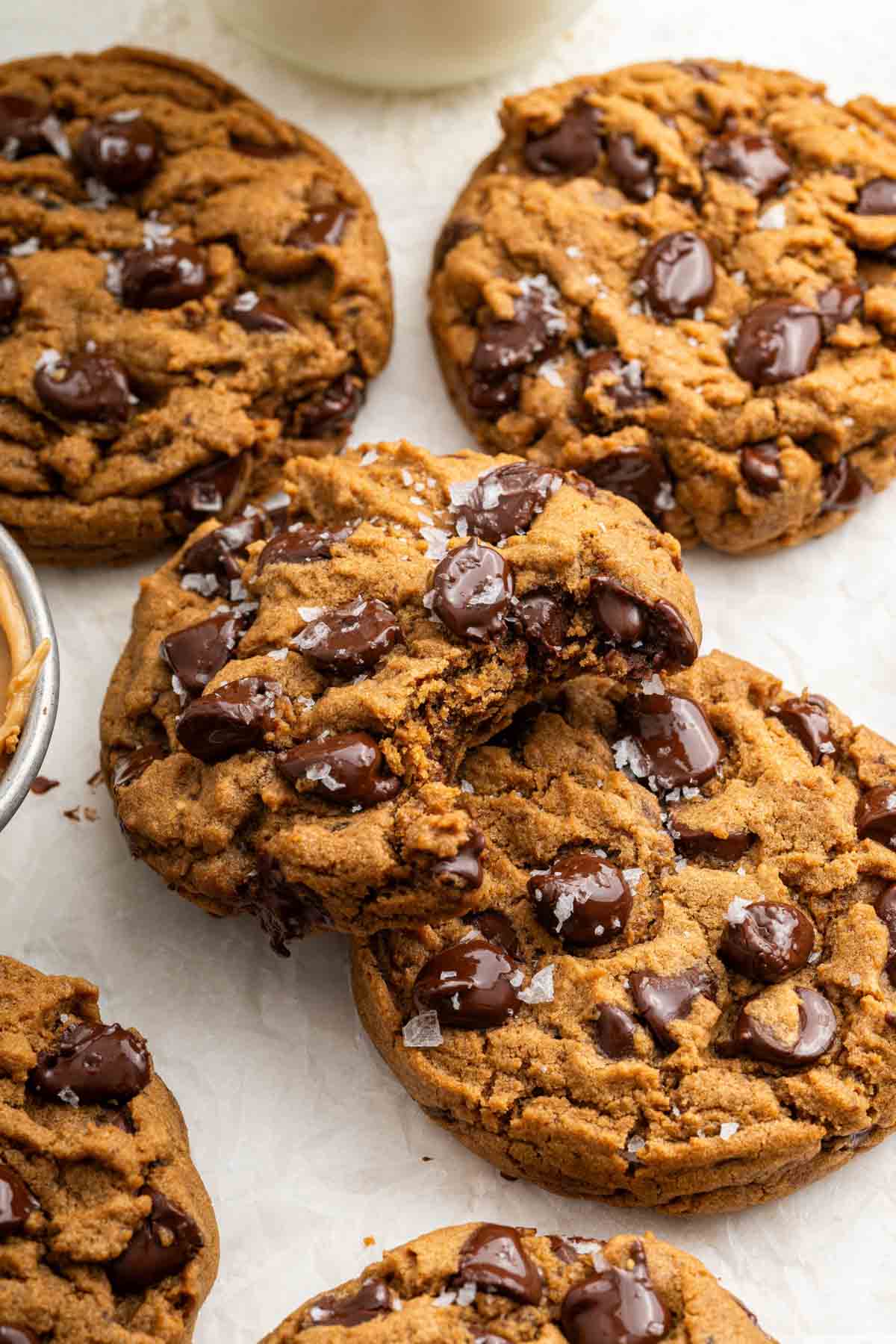 Peanut butter chocolate chip cookies stacked on each other with a bite missing.