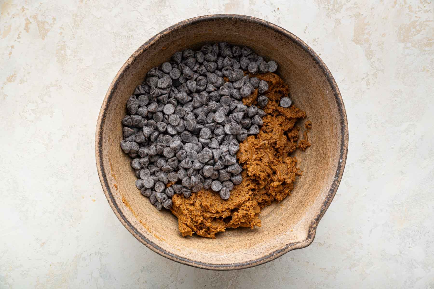 Chocolate chips in peanut butter cookie dough batter.