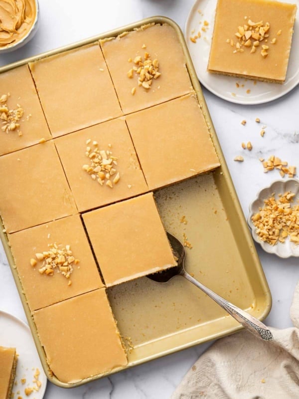 Overhead shot of peanut butter sheet cake cut into 12 equal squares.