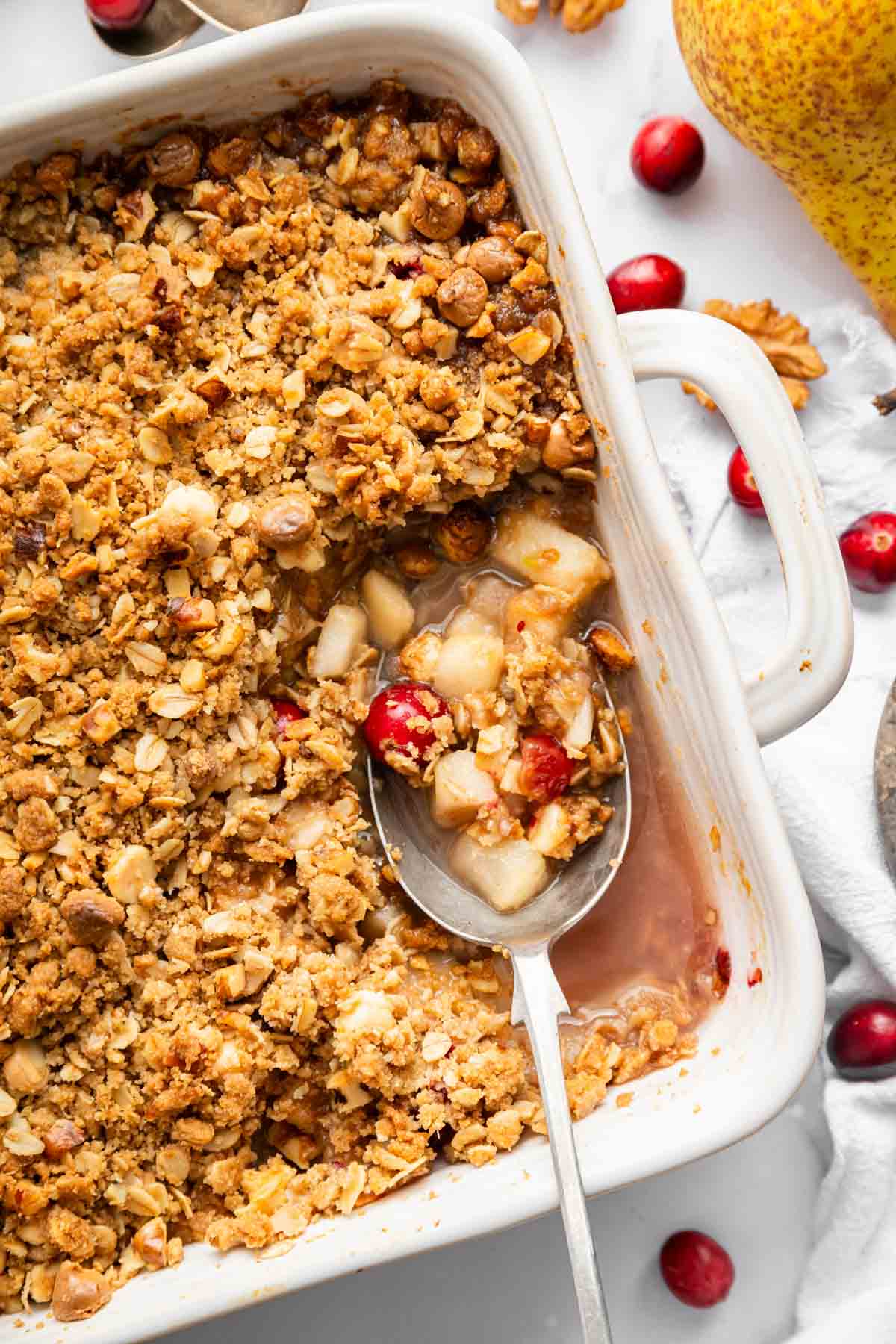 DessertForTwoPearCranberryCrisp2 Overhead shot of pear cobbler in a square dish with cranberries.
