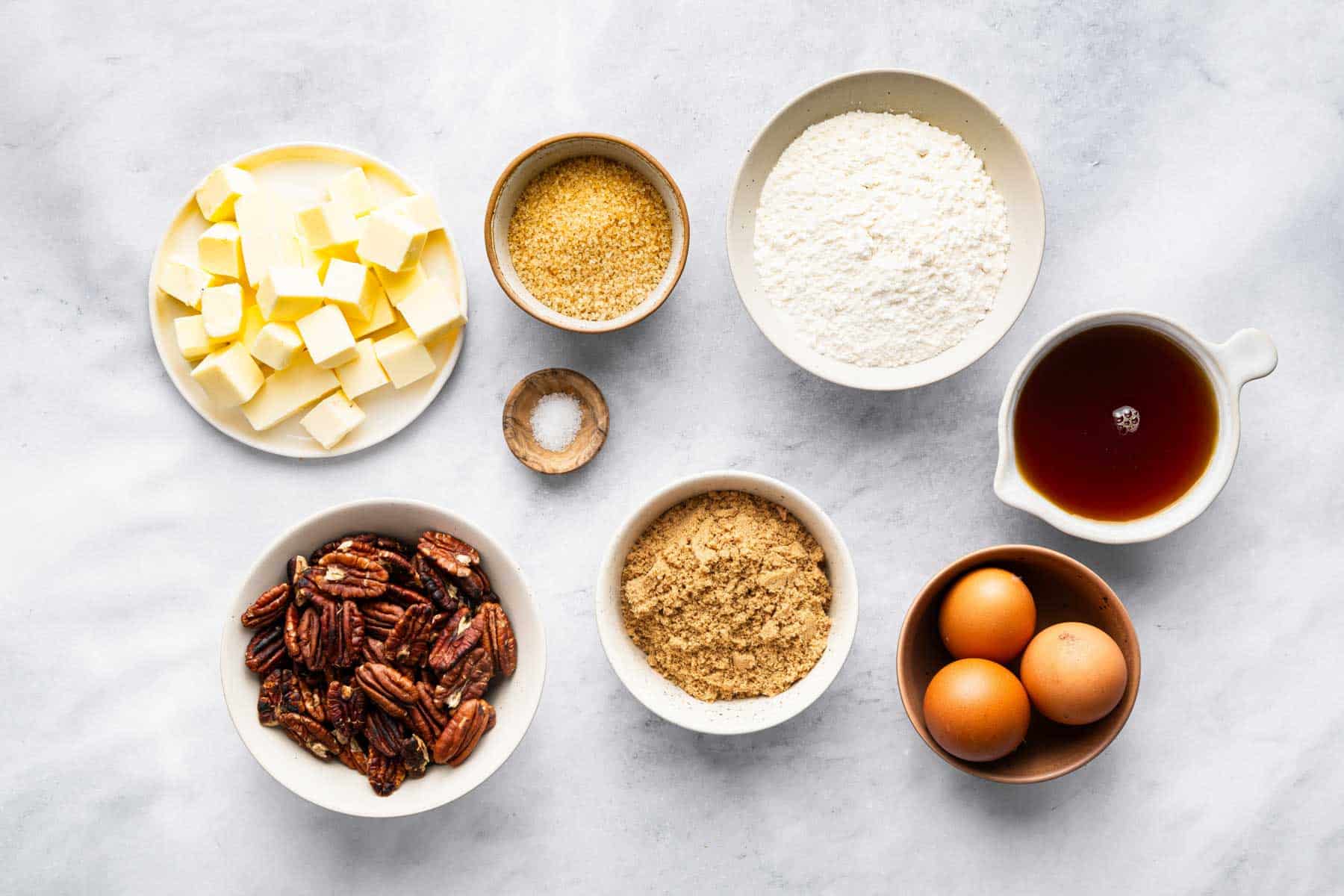 Small bowls of nuts, sugars, and butter.