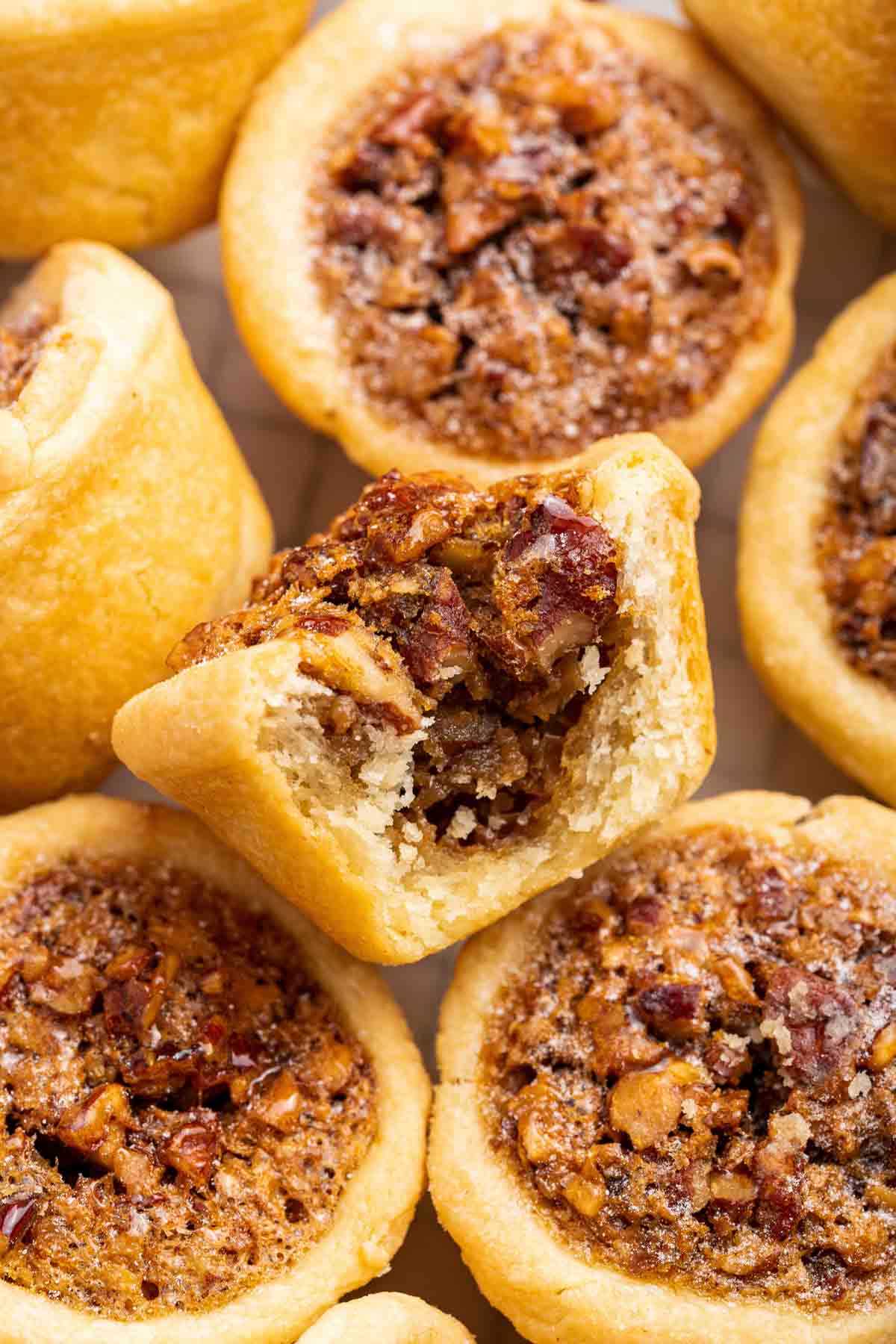 Close up of pecan tassie with bite missing.