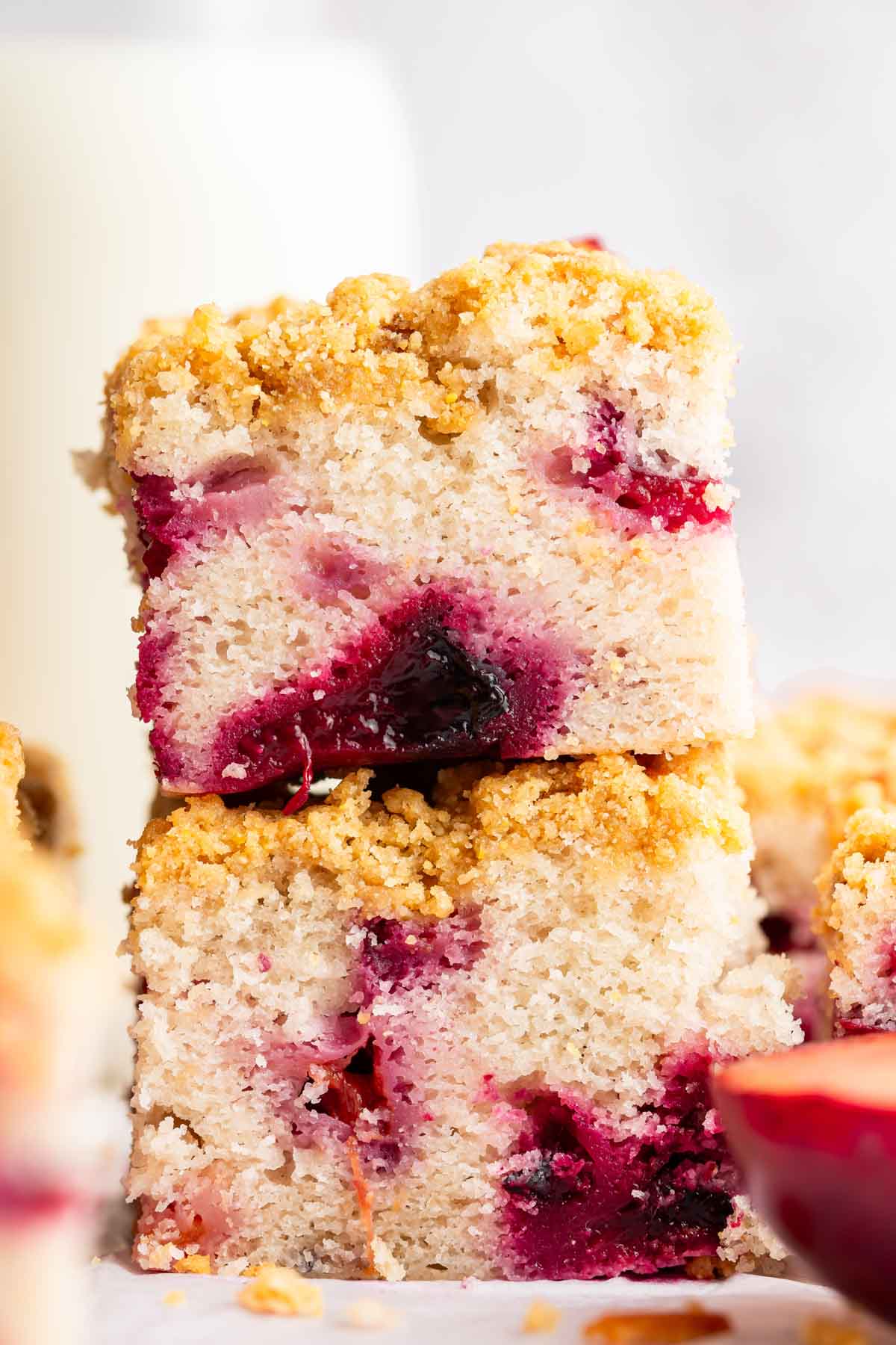 Two slices of plum cake stacked on top of each other.