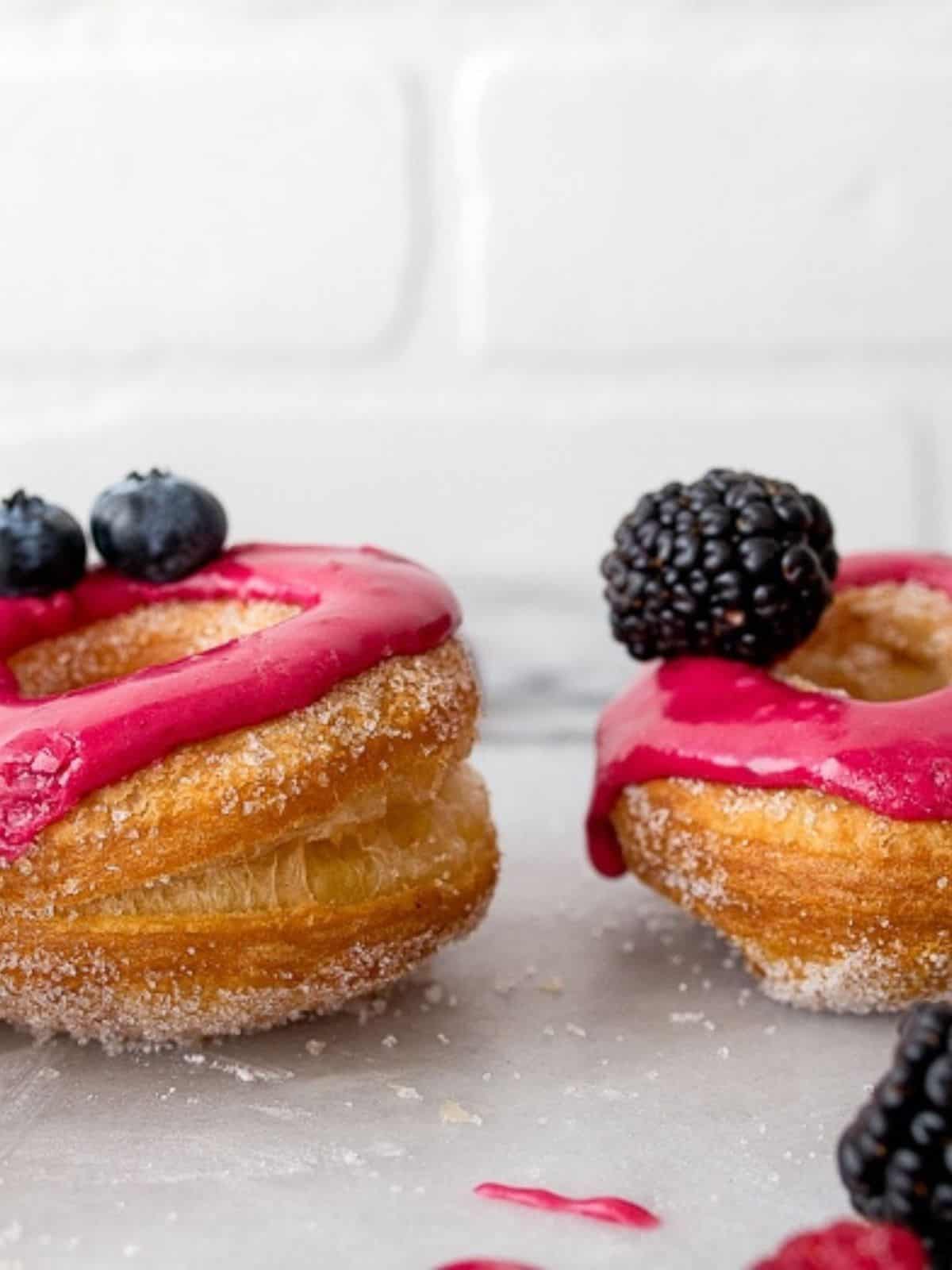 Close up of edges of puff pastry donuts showing dough lamination.