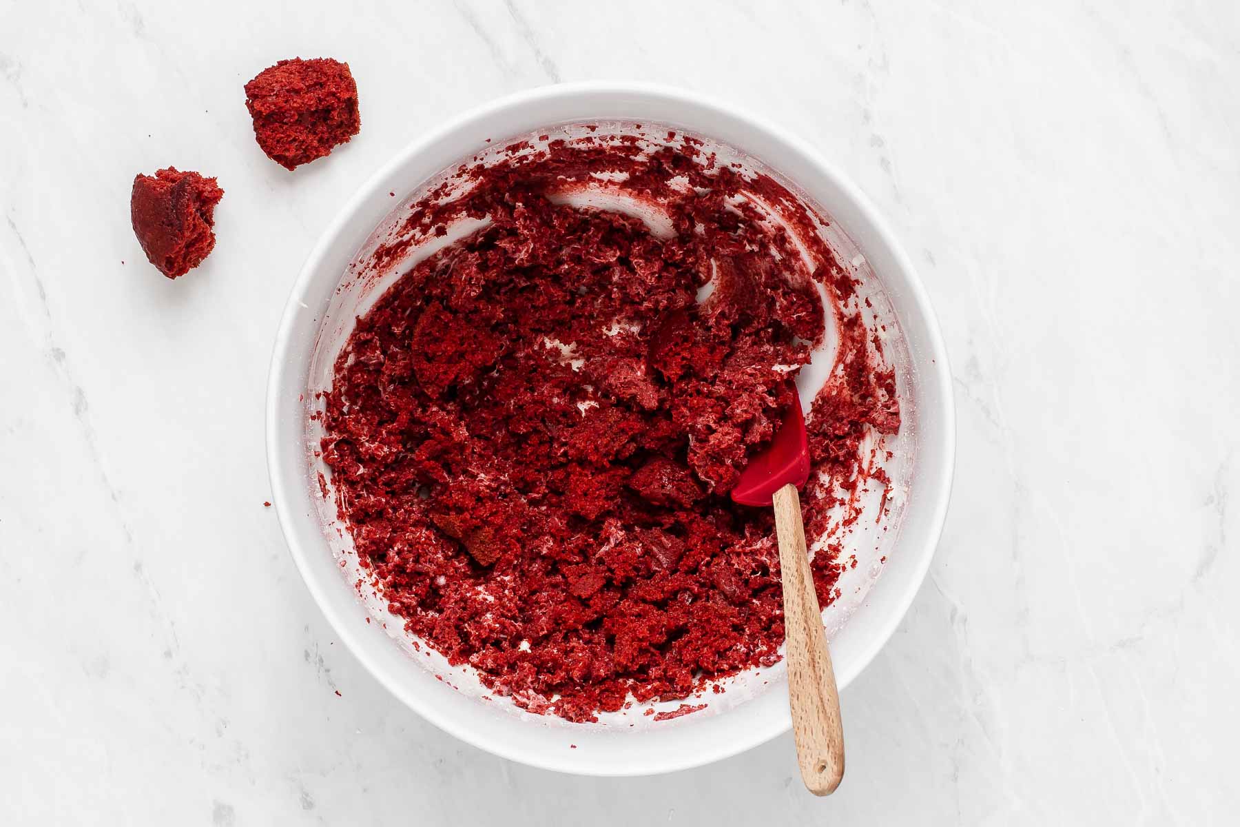 Making red velvet cake pops in a bowl.