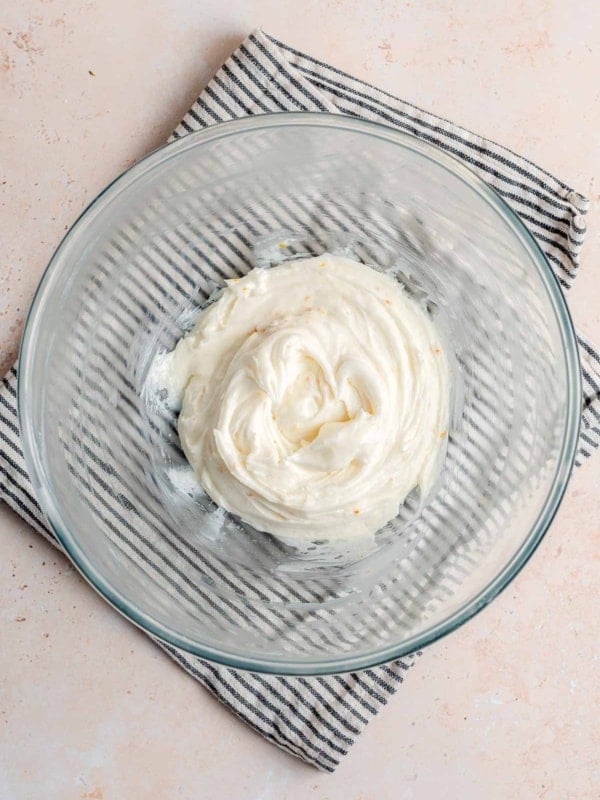 Ricotta frosting in a clear glass bowl.