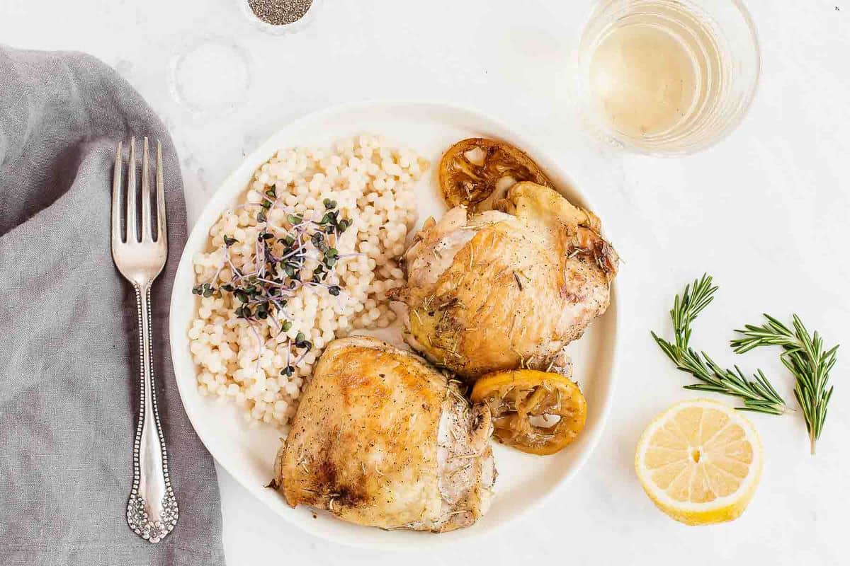 plate of chicken thighs with pasta and micro greens