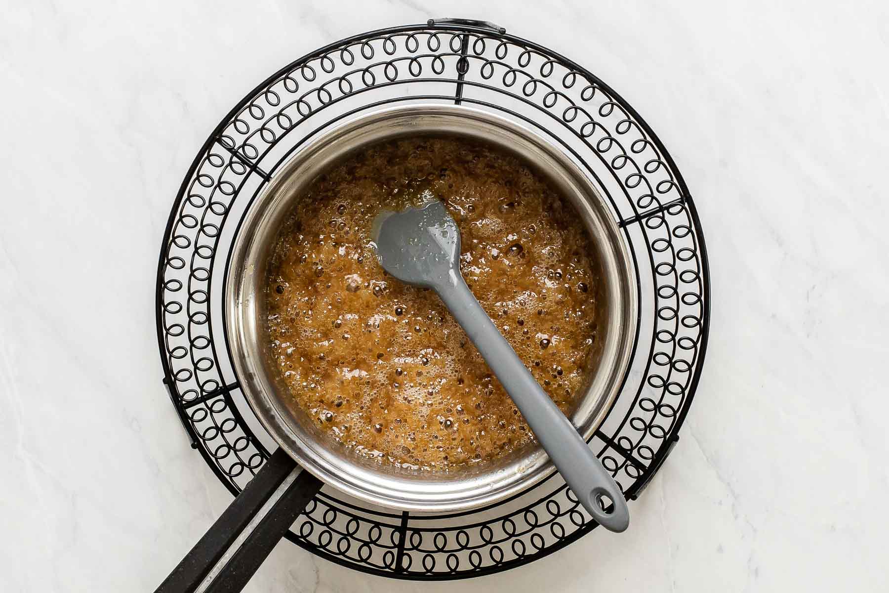 Boiling brown sugar and butter in a small saucepan.