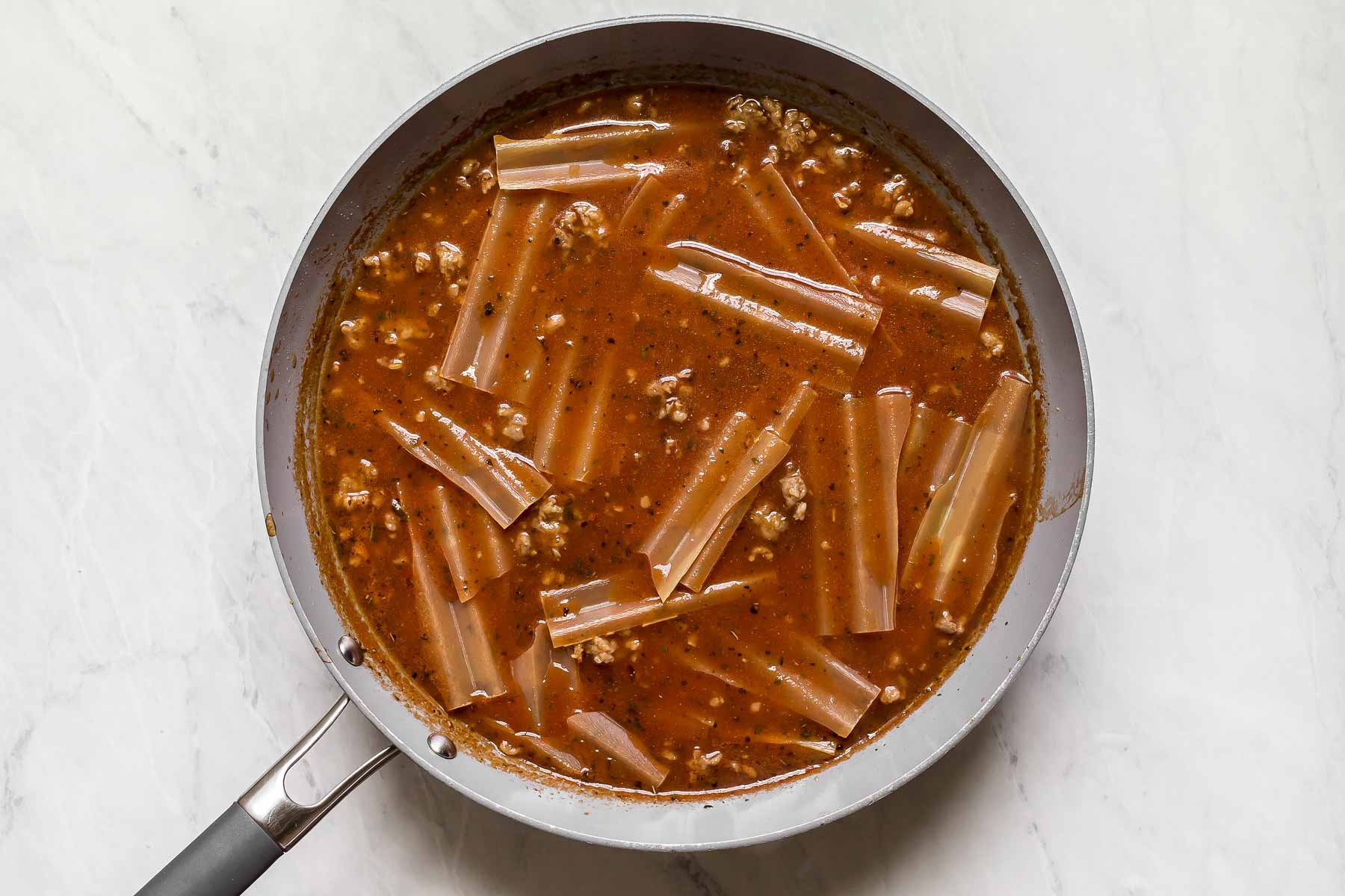 Broken noodles in lazy lasagna skillet.