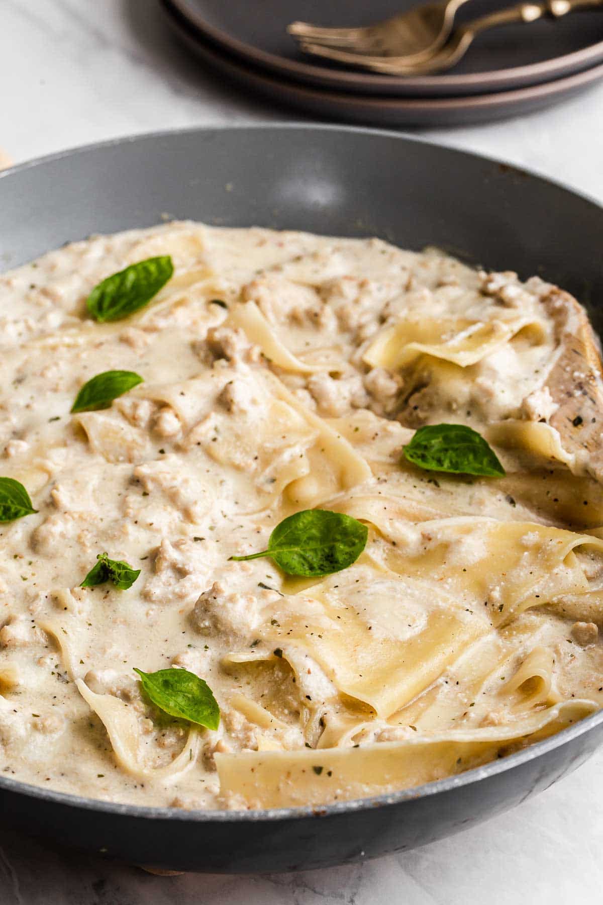 White chicken lasagna in a skillet.