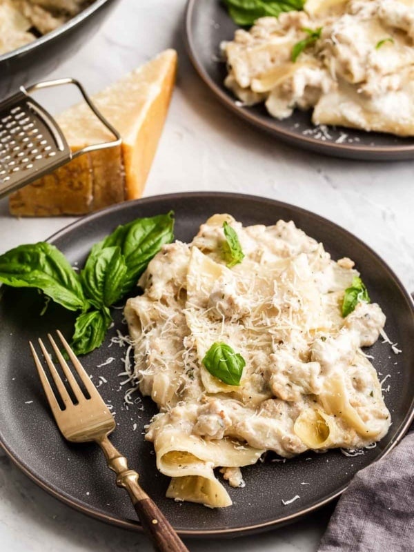 Skillet White Chicken Lasagna on black plate with fork.